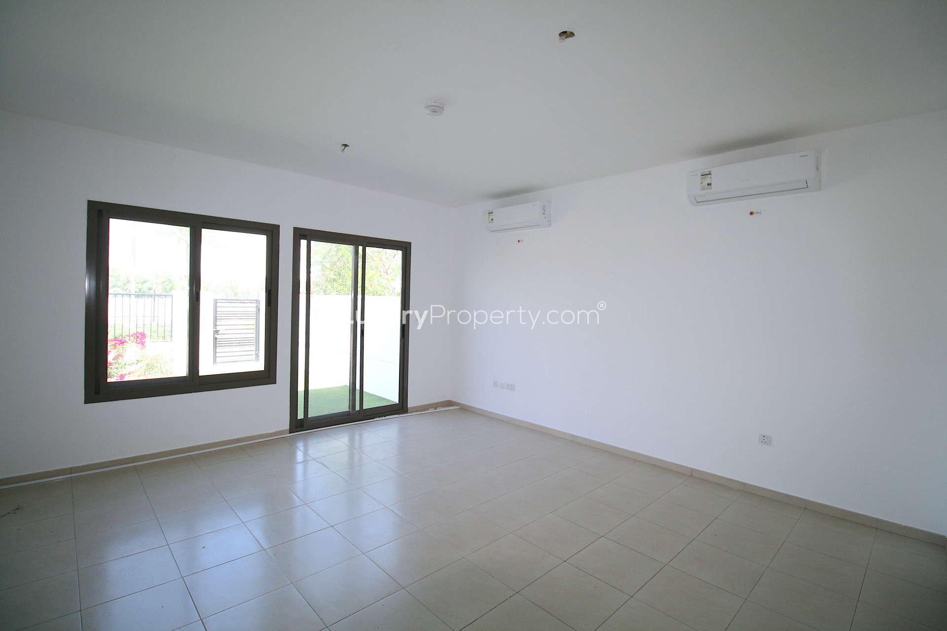 Modern kitchen and living area in Zahra Townhouses, Town Square. Spacious 4-bed rental