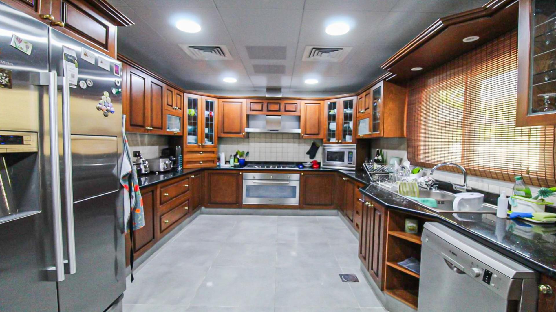 Spacious living area in upgraded 4-bedroom villa, Meadows 9, featuring elegant decor and furnishings