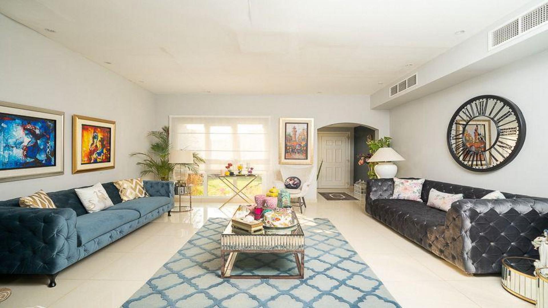 Luxurious living room in fully upgraded Meadows 9 villa with garden view