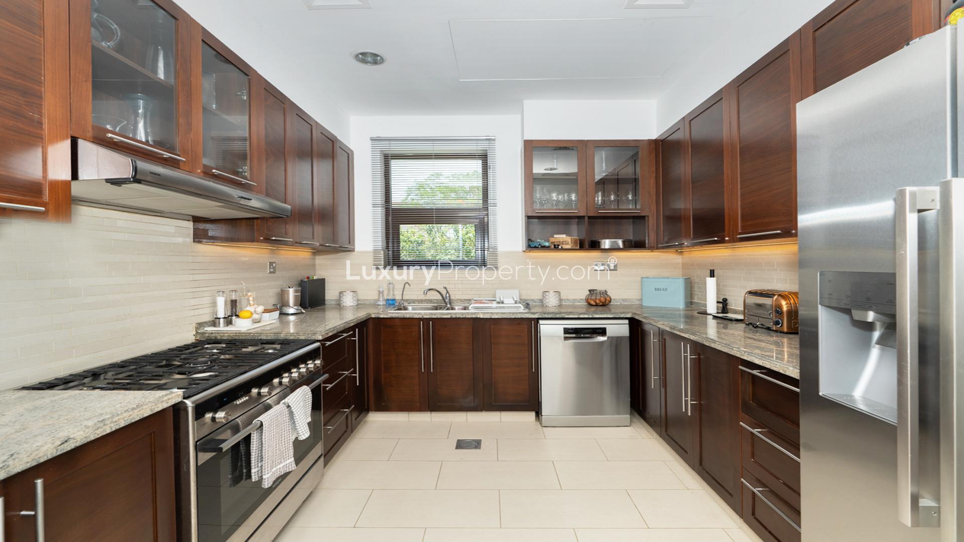 Modern kitchen in 4-bedroom villa, Arabian Ranches 2, Casa community, with sleek cabinetry and appliances