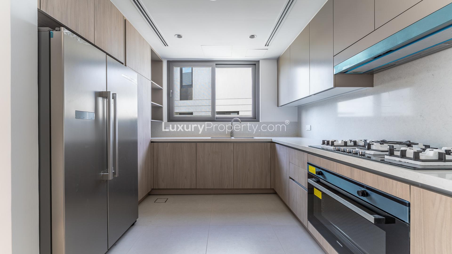 Chic and spacious living area in Tilal Al Ghaf twin villa with large windows