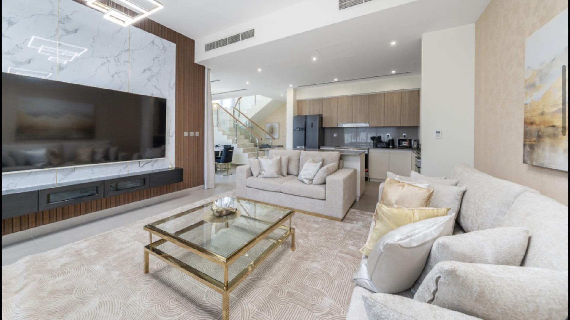 Modern living room in Sidra Villa, Dubai Hills Estate, featuring elegant decor and garden view