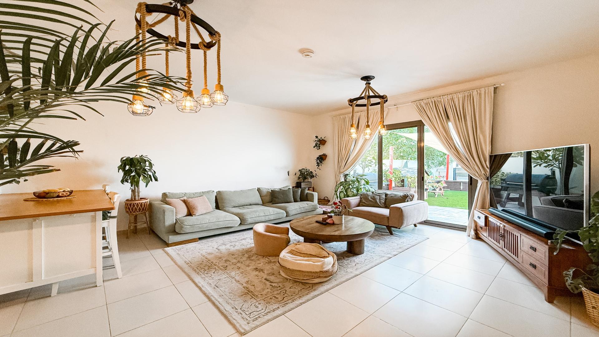 Modern living room in Noor Townhouses villa, featuring cozy seating and stylish decor