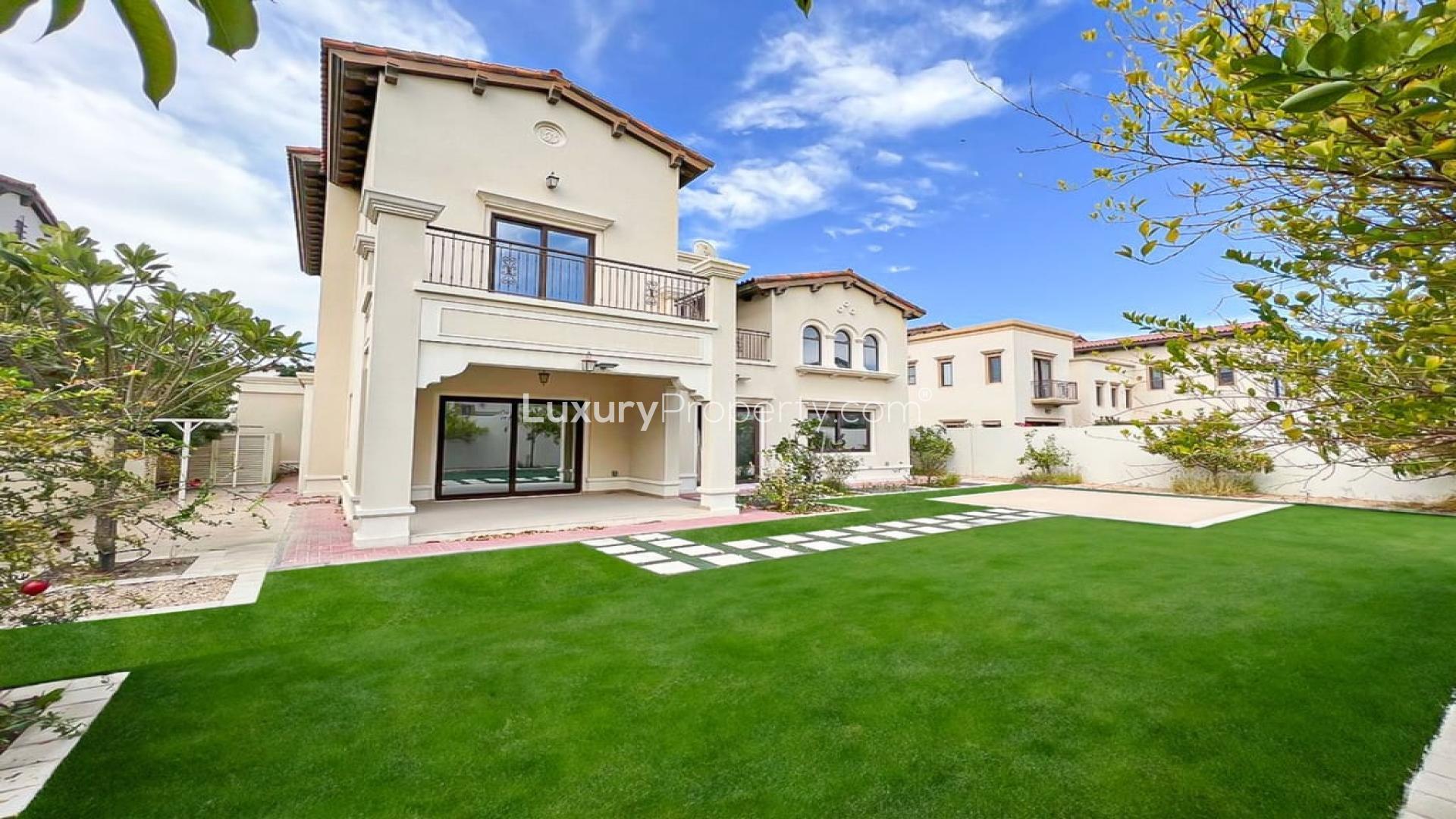 Luxury 4-bedroom villa exterior with lush garden in Rasha