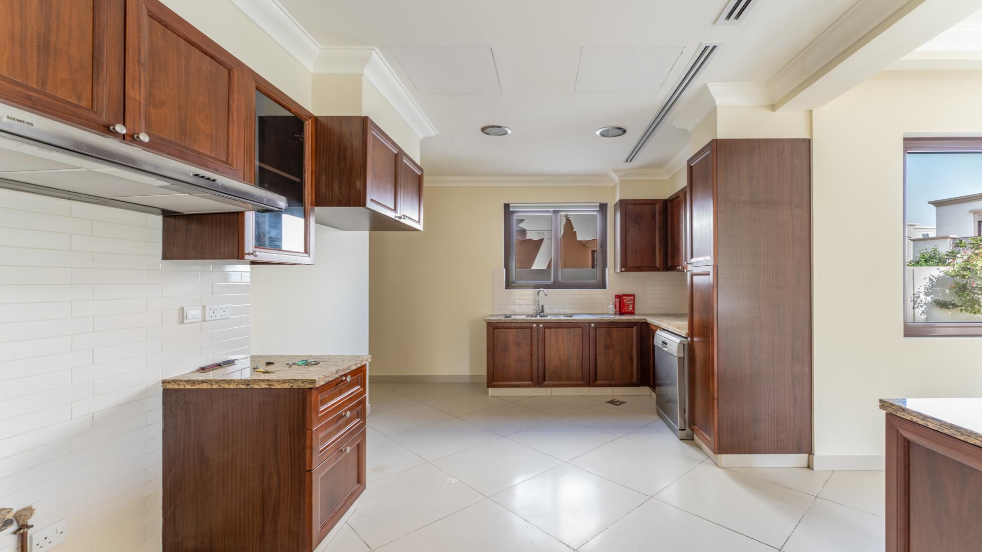 Open plan living area in Yasmin Villa, Arabian Ranches 2, with natural light and garden view