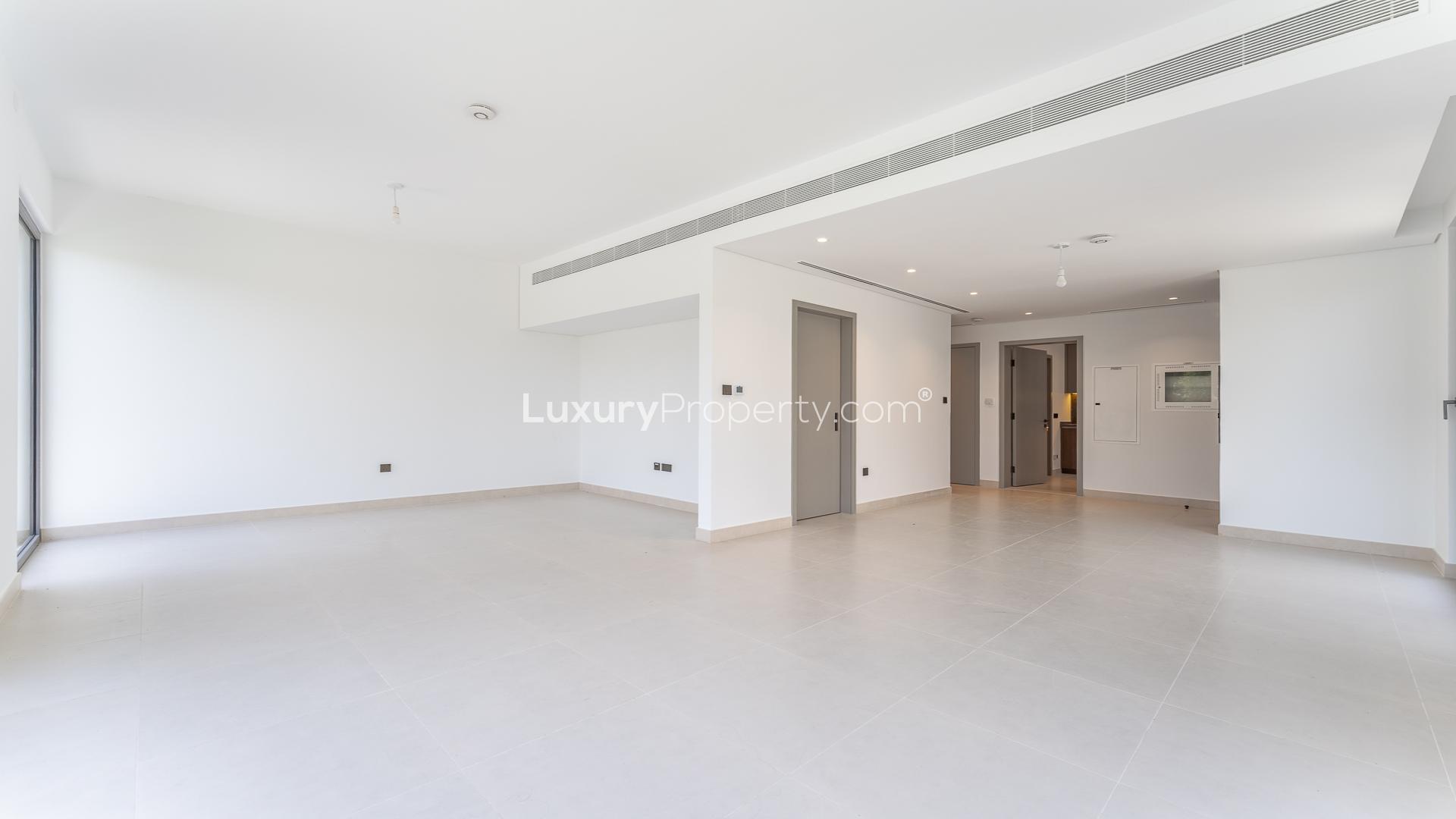 Empty living room in stylish four-bedroom villa for rent in Aura, Tilal Al Ghaf