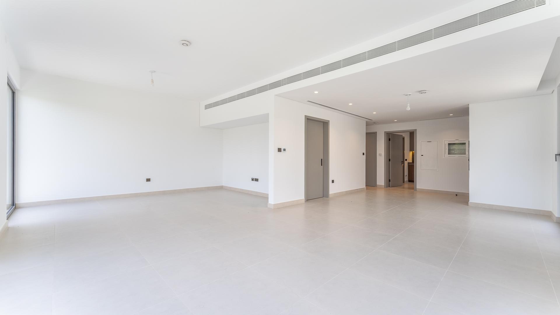 Empty living room in stylish four-bedroom villa for rent in Aura, Tilal Al Ghaf