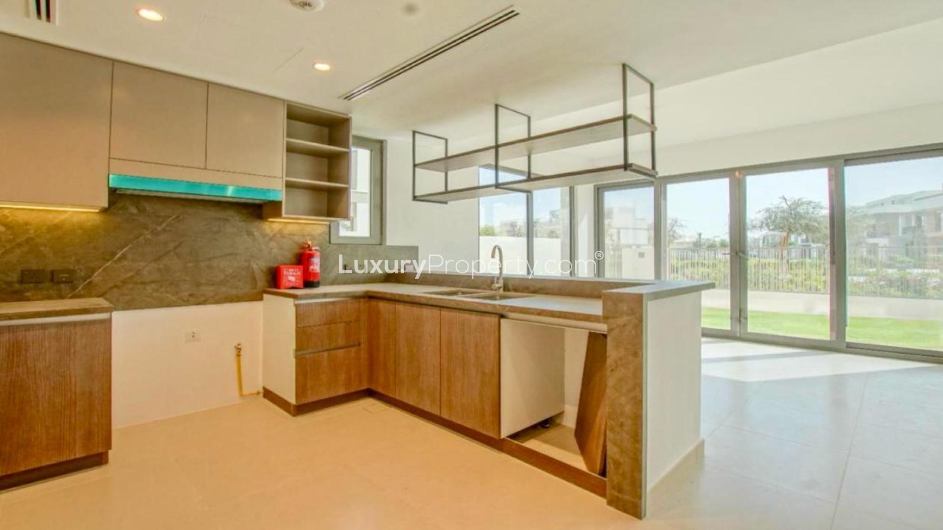 Modern open-plan kitchen and living area in 4-bedroom villa, Aura, Tilal Al Ghaf