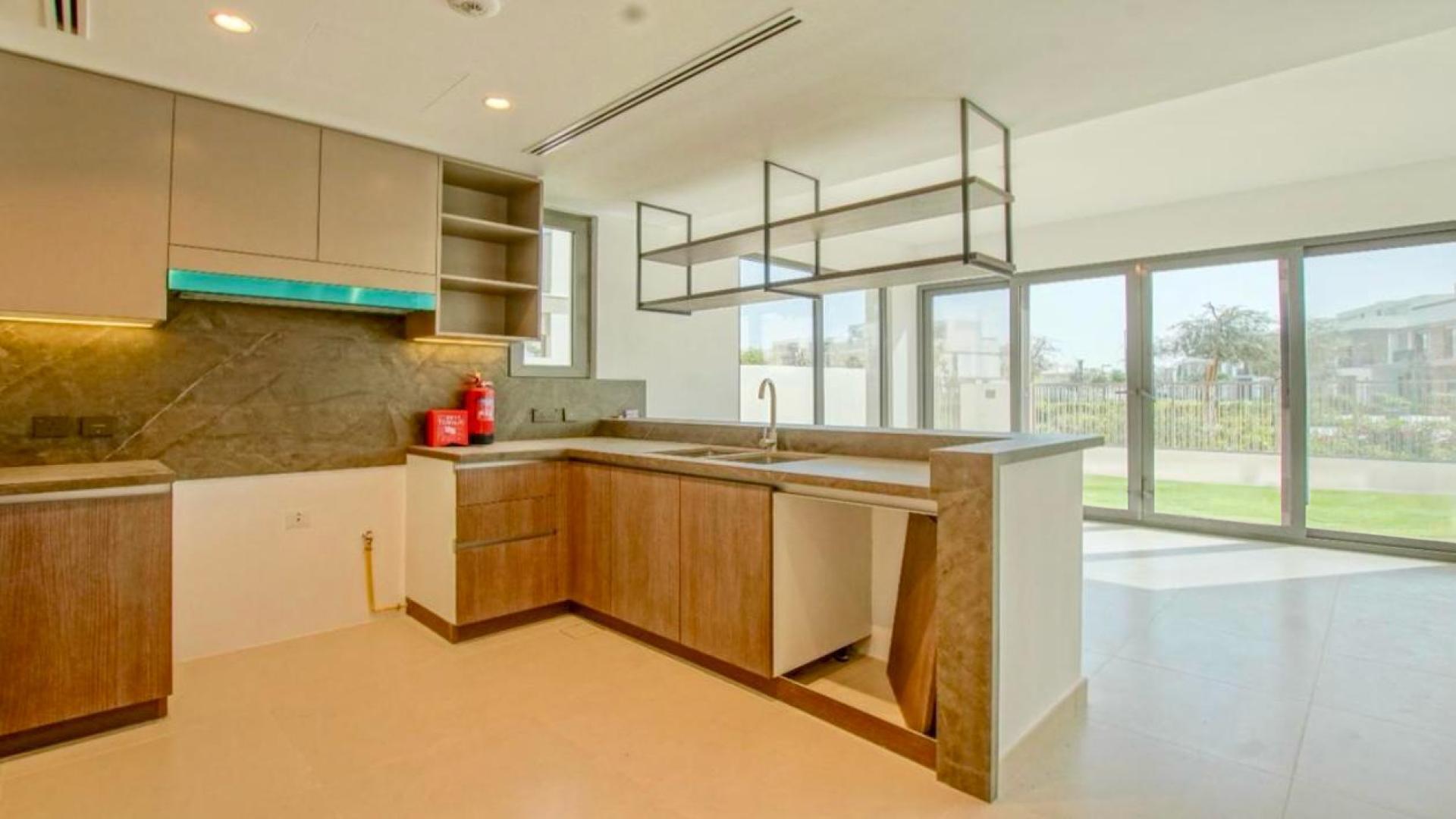 Modern open-plan kitchen and living area in 4-bedroom villa, Aura, Tilal Al Ghaf