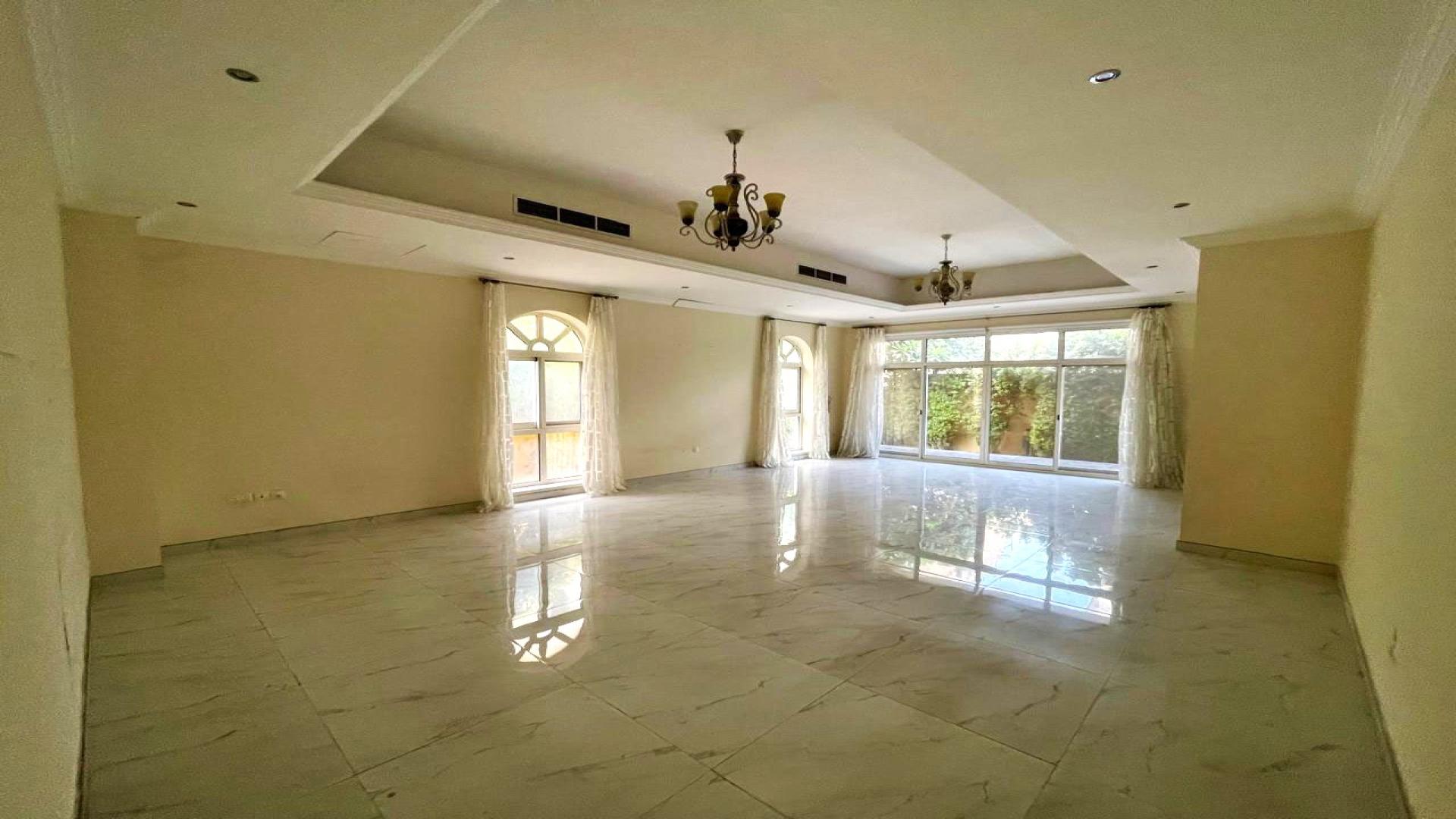 Front entrance of 4-bedroom villa in The Aldea with lush greenery and spacious patio