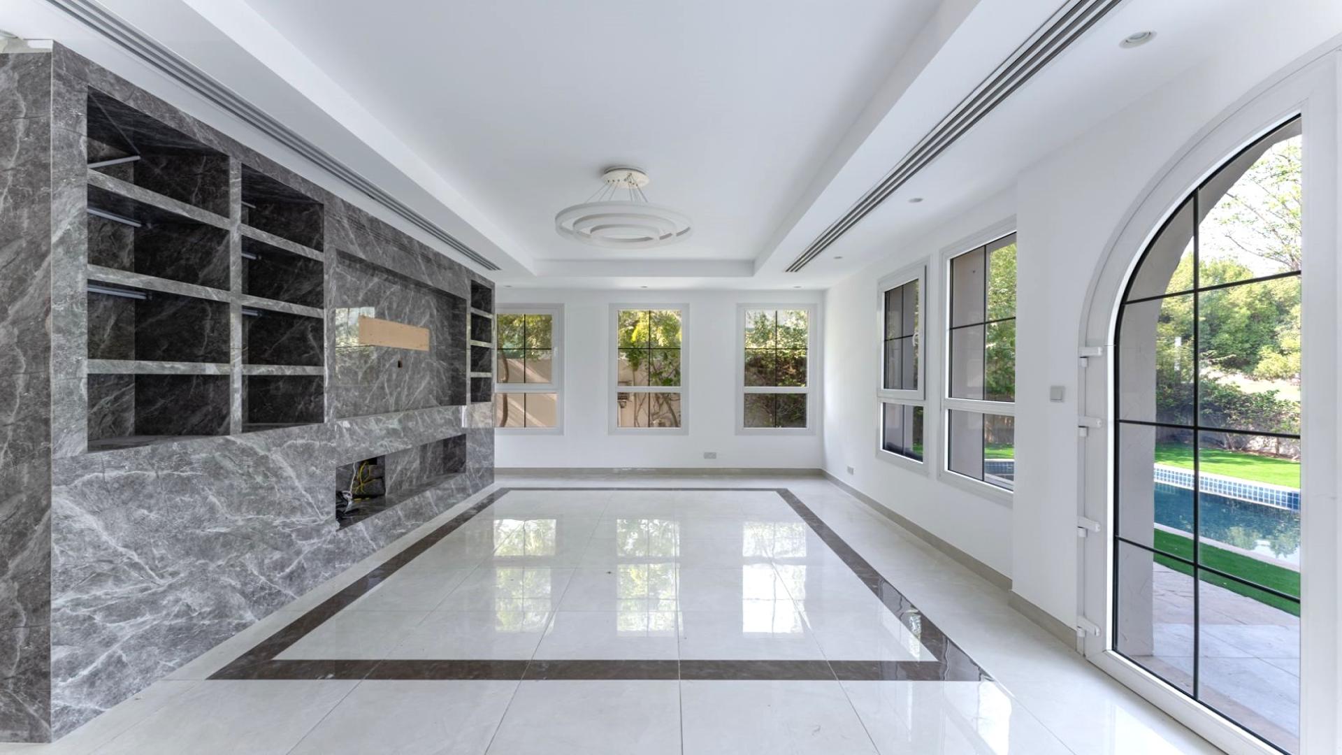"Luxurious villa pool and garden in Jumeirah Golf Estates, Earth community, for rent.",Luxurious living room with marble accents and pool view in Jumeirah Golf Estates villa