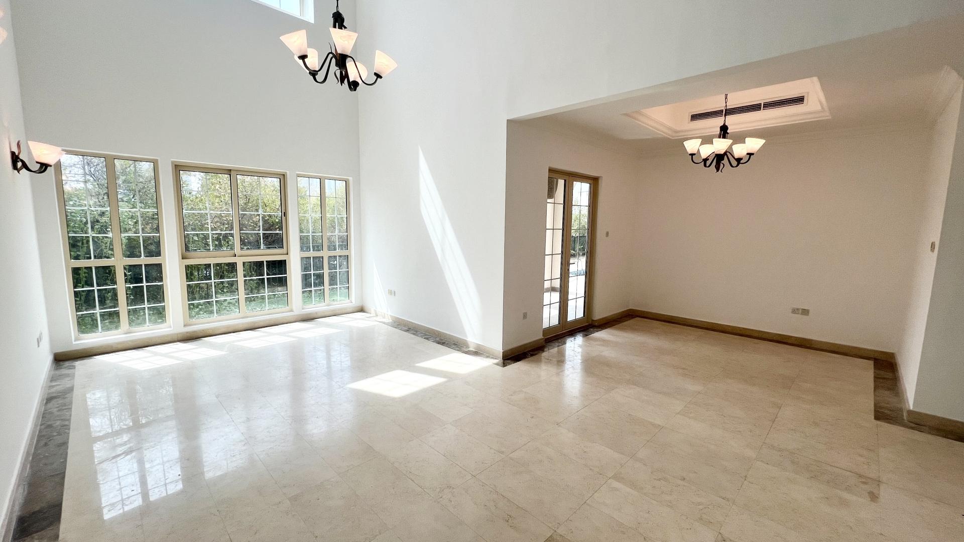 "Balcony view of skyline and waterway from Jumeirah Islands Mediterranean Clusters villa.",Bright living area in 4-bedroom villa, Jumeirah Islands, Mediterranean Clusters, large windows, marble floor