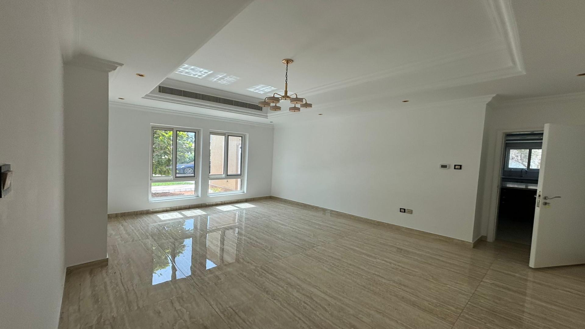 "Spacious living room with large windows, pool view in Jumeirah Islands villa for rent.",Spacious living room in Jumeirah Islands villa with large windows and elegant flooring