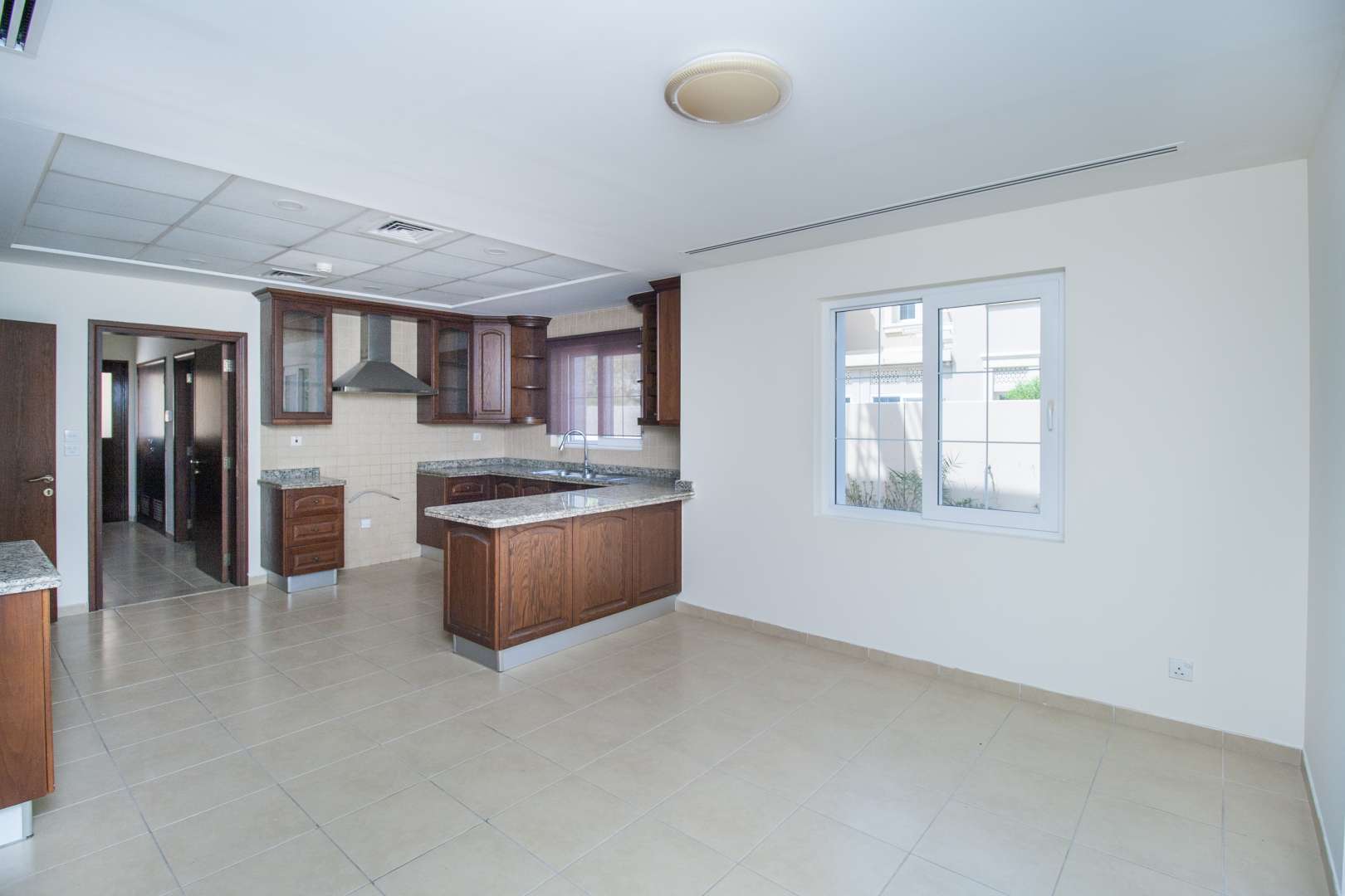 Spacious kitchen with wooden cabinets in 4-bedroom villa, Alvorada 2, Arabian Ranches