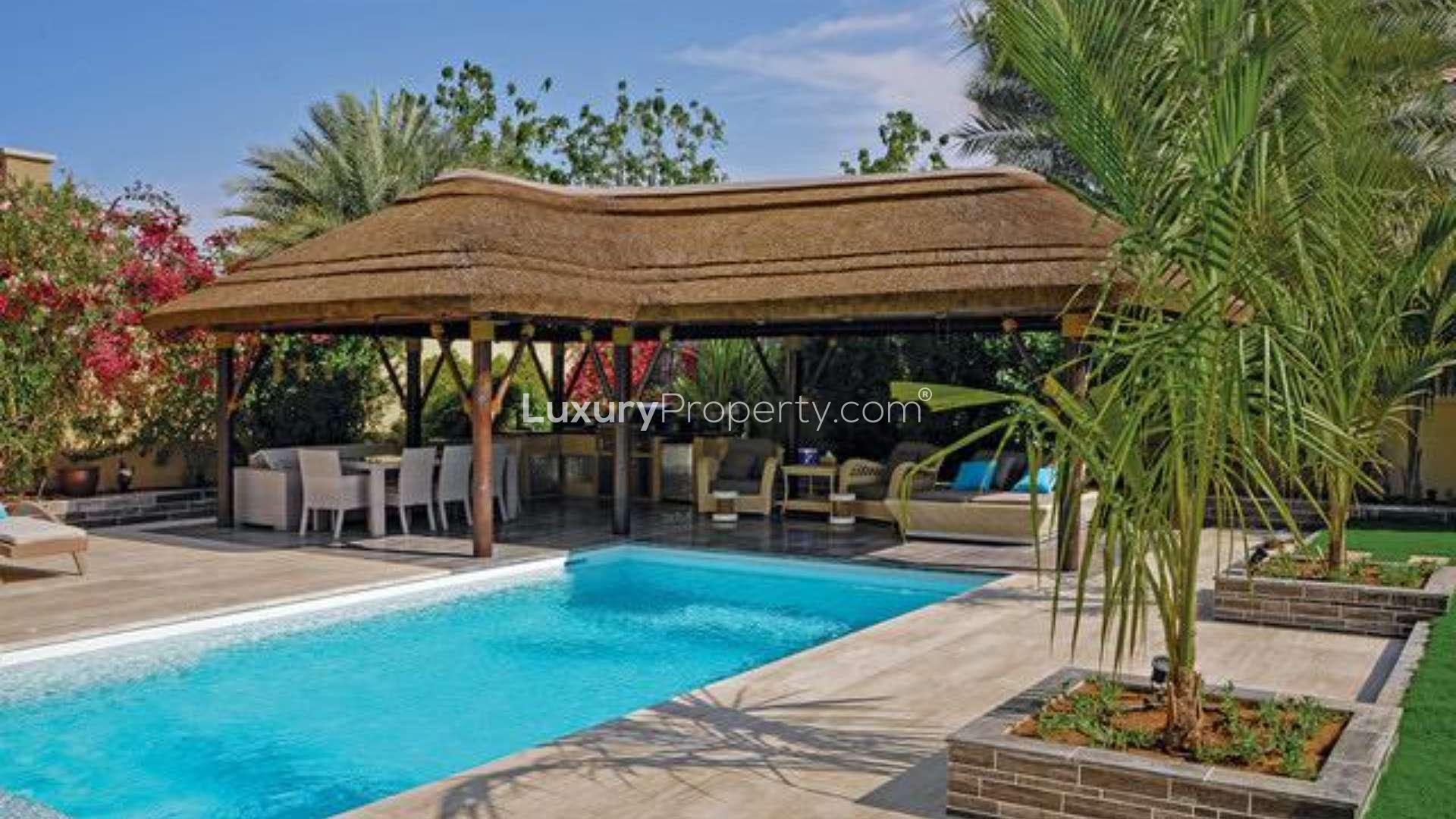 Private pool with shaded seating area in Alvorada Villa, Arabian Ranches