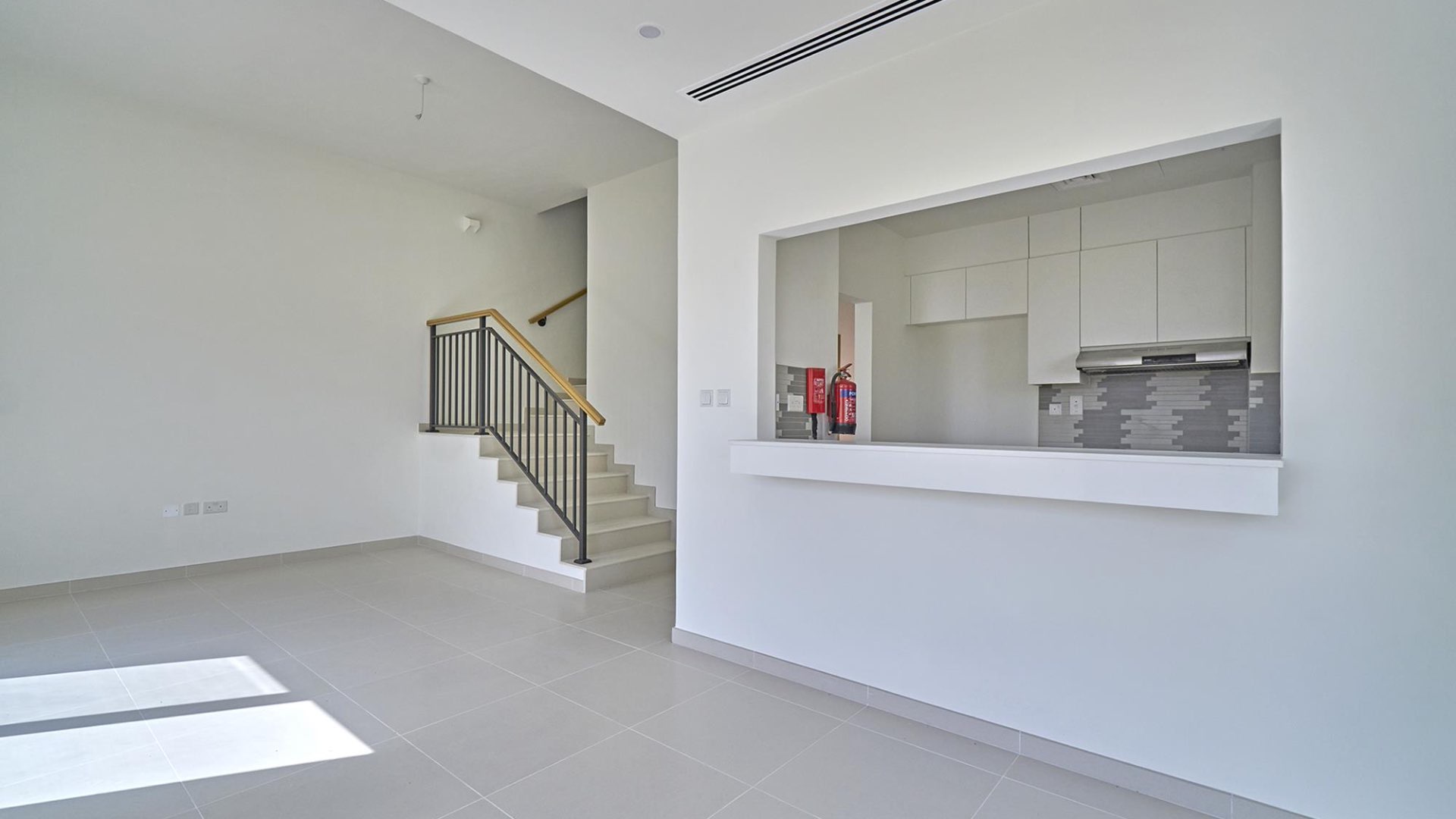 Modern kitchen in 4-bedroom villa, Amaranta, Villanova, Dubai, with sleek cabinetry and backsplash