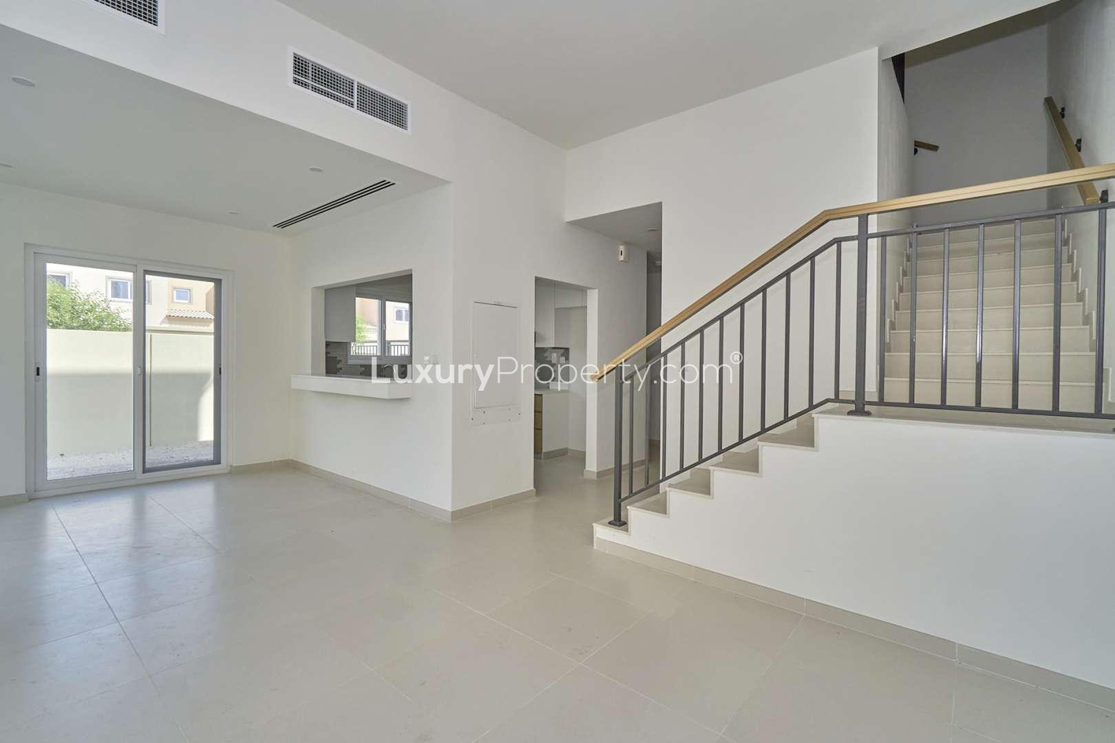 Modern open-plan kitchen and staircase in 4-bedroom villa, Villanova, Dubai Land for rent