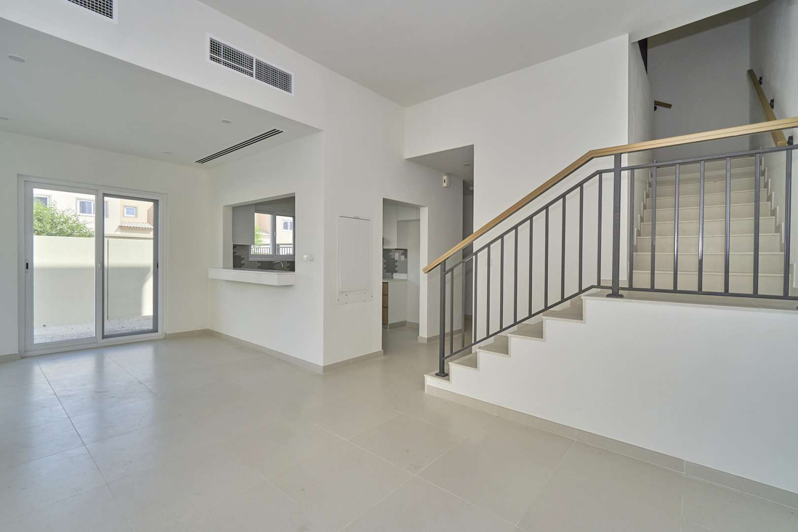 Modern open-plan kitchen and staircase in 4-bedroom villa, Villanova, Dubai Land for rent