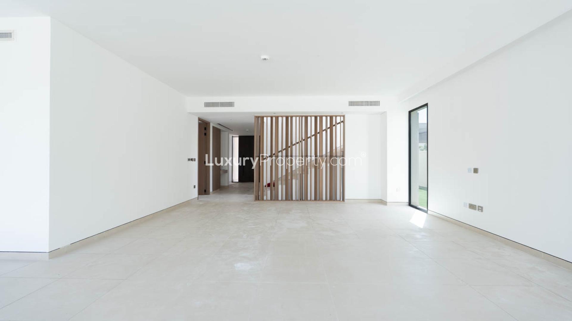 Spacious living area with large windows in Tilal Al Ghaf Harmony 2 villa