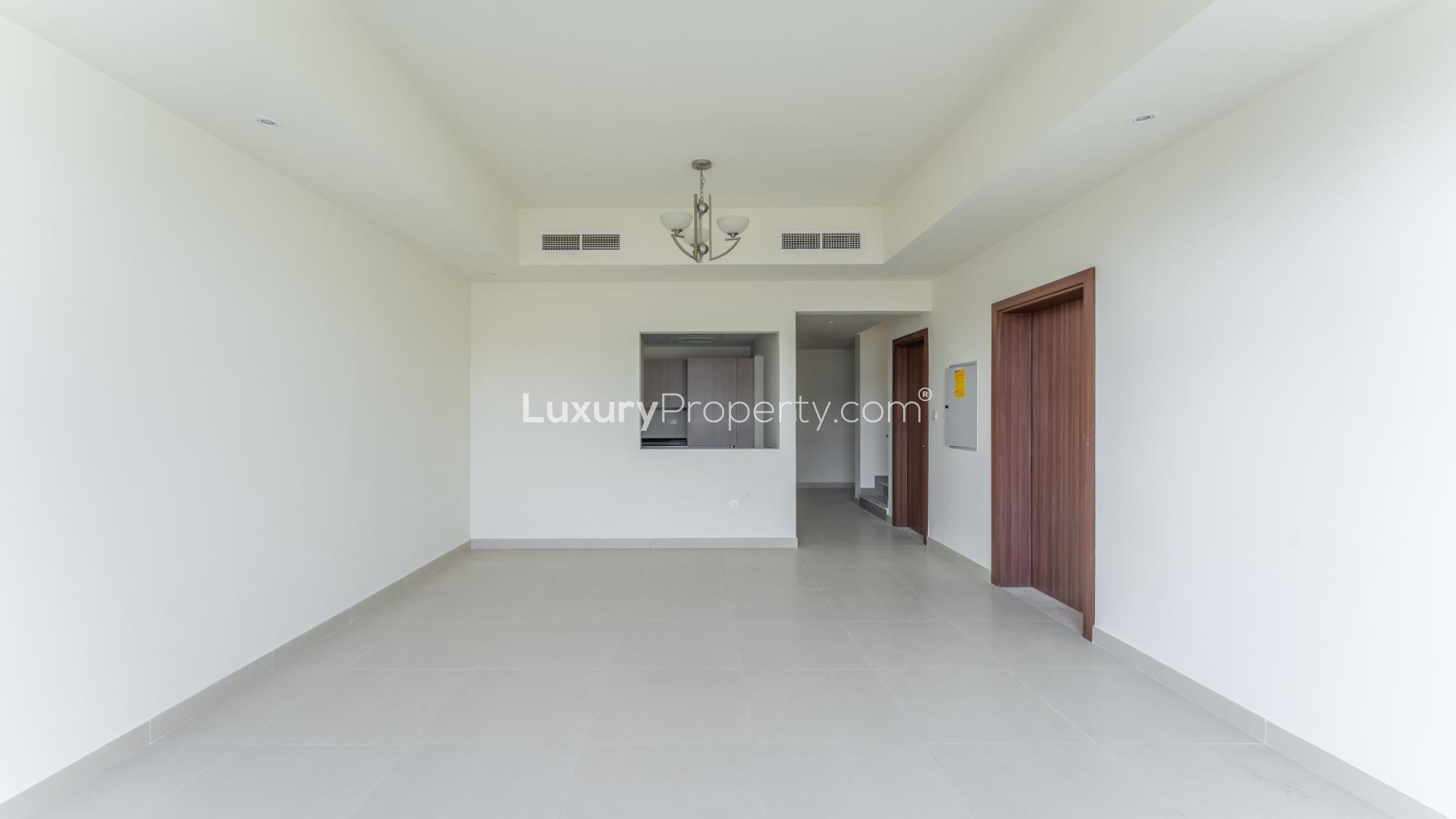 "Balcony view of modern villas in District 11, Mohammed Bin Rashid City, for rent.","Spacious living area with high ceilings in District 11 villa, Mohammed Bin Rashid City.",Modern kitchen with sleek cabinetry in Mohammed Bin Rashid City villa for rent