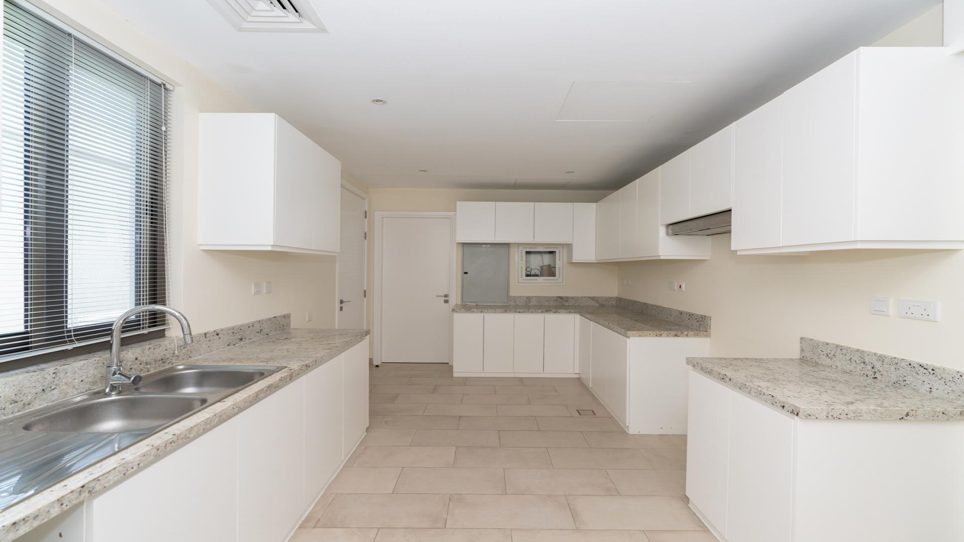 Spacious living area in Azalea Villa, Arabian Ranches 2, with large windows and tiled floors