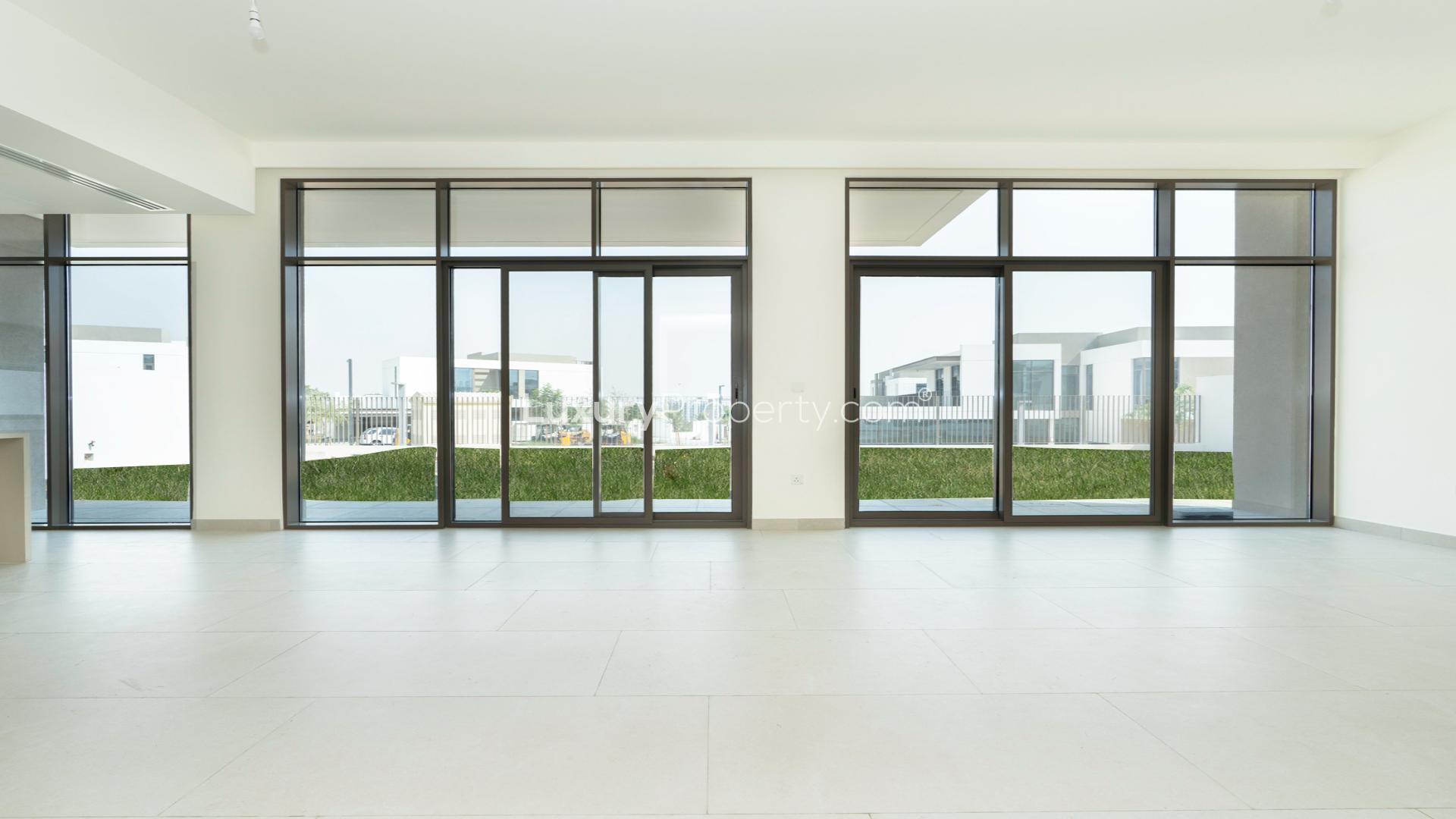 Spacious open-plan living area with large windows in Al Furjan villa, Tilal Al Furjan