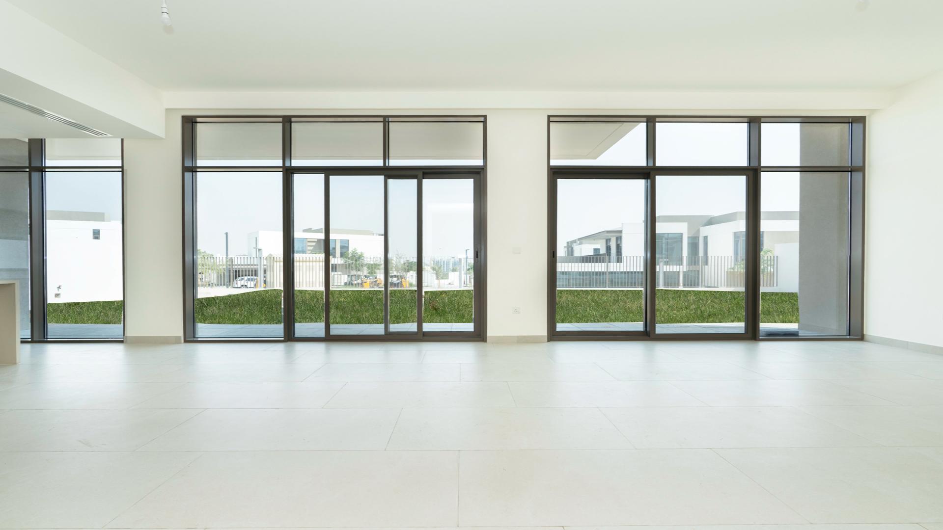 Spacious open-plan living area with large windows in Al Furjan villa, Tilal Al Furjan