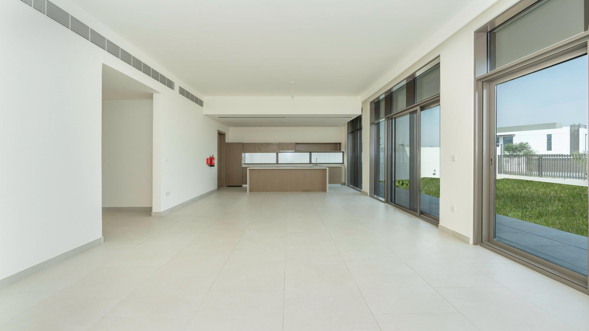 Spacious living area with large windows in Tilal Al Furjan villa, Al Furjan community
