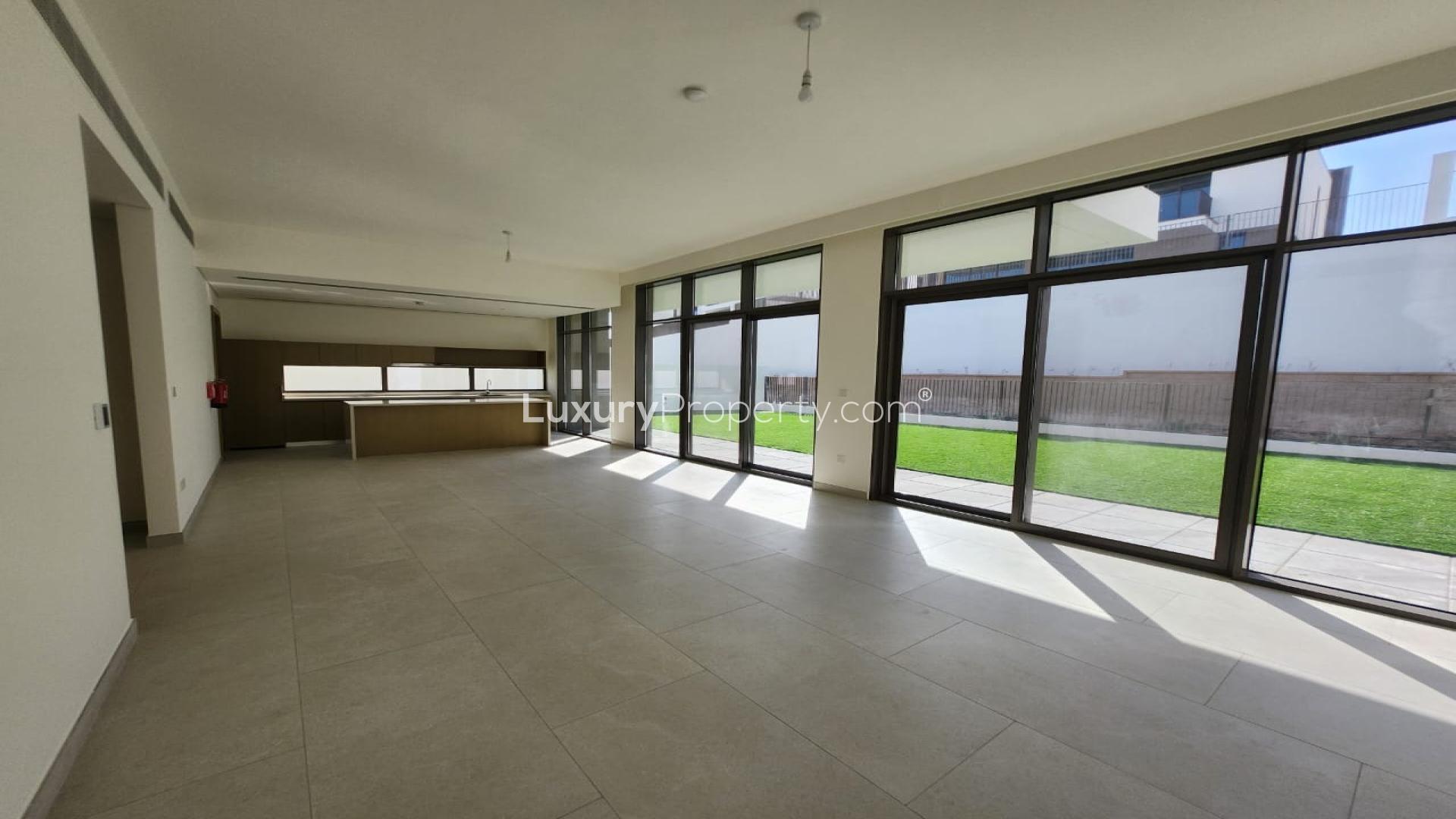 Modern bathroom in Tilal Al Furjan villa, featuring double sinks and glass shower enclosure