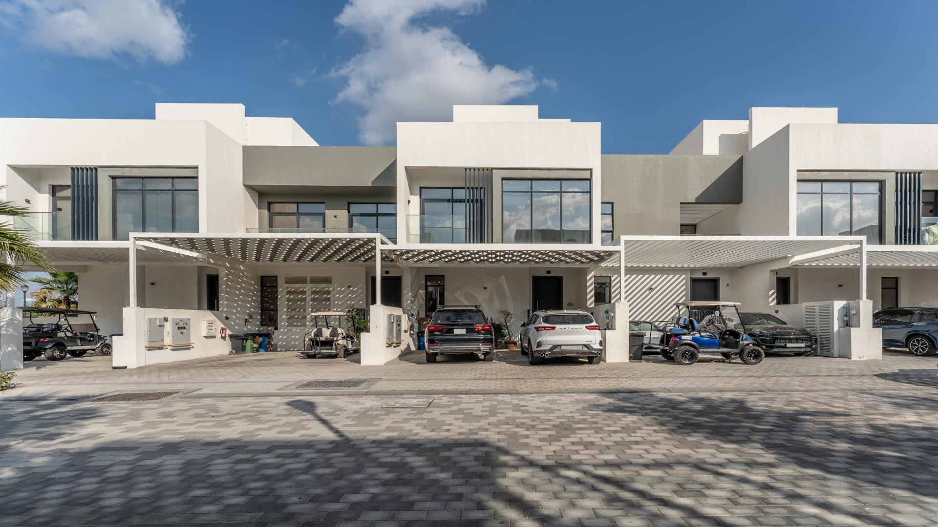 Bright living room in 4-bedroom villa, Jumeirah Golf Estates, with garden view and modern decor