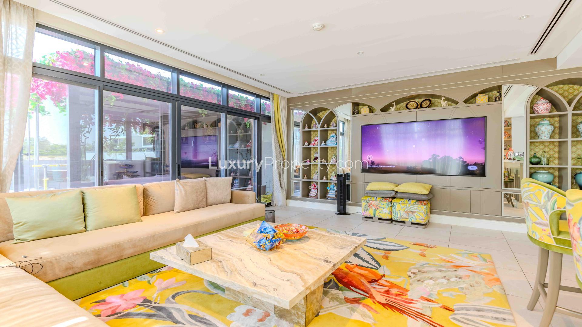 Luxurious Jumeirah Golf Estates villa living room with vibrant decor and modern kitchen