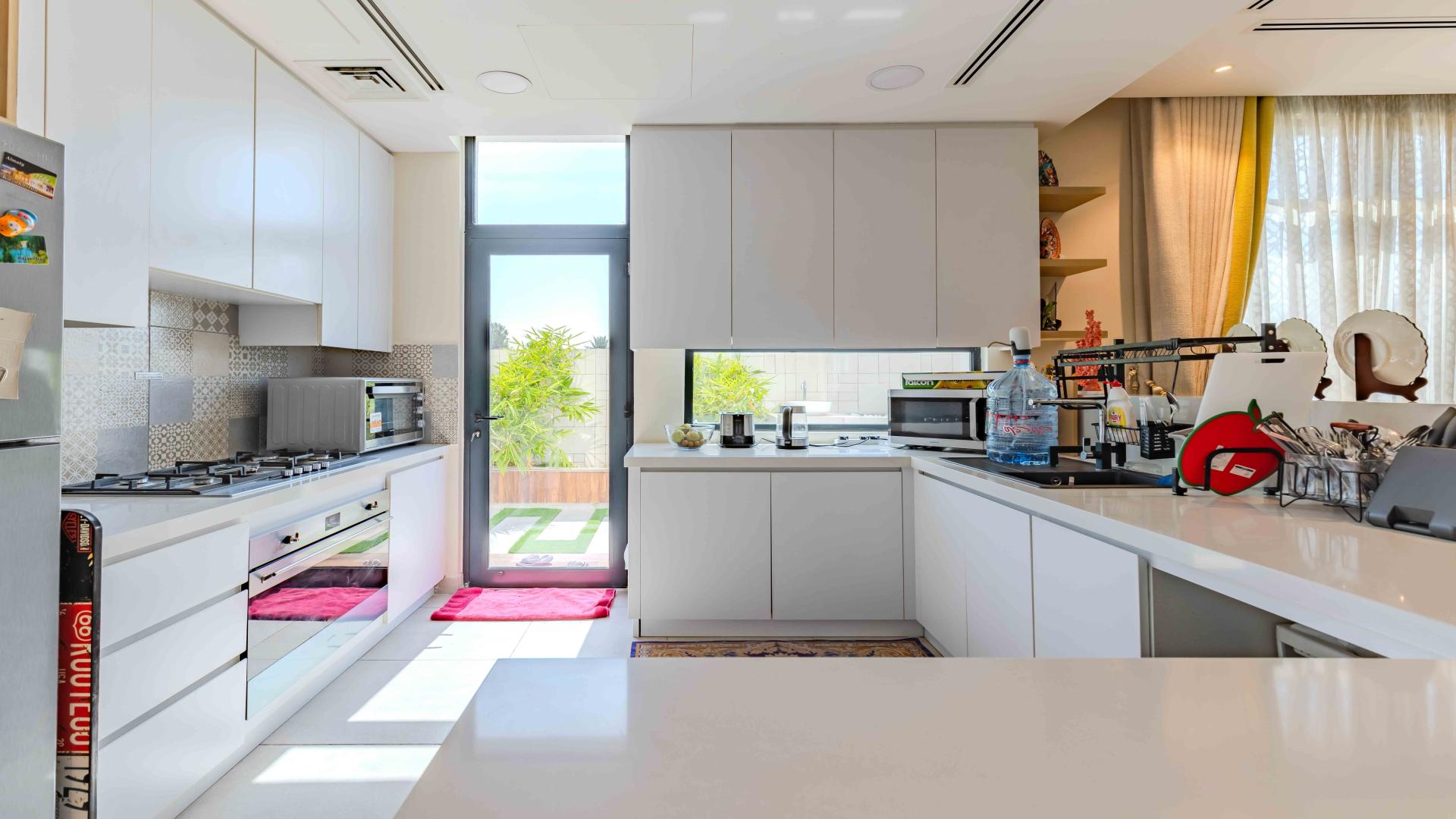 Luxurious living room in 4-bedroom Jumeirah Golf Estates villa, featuring modern decor and large windows