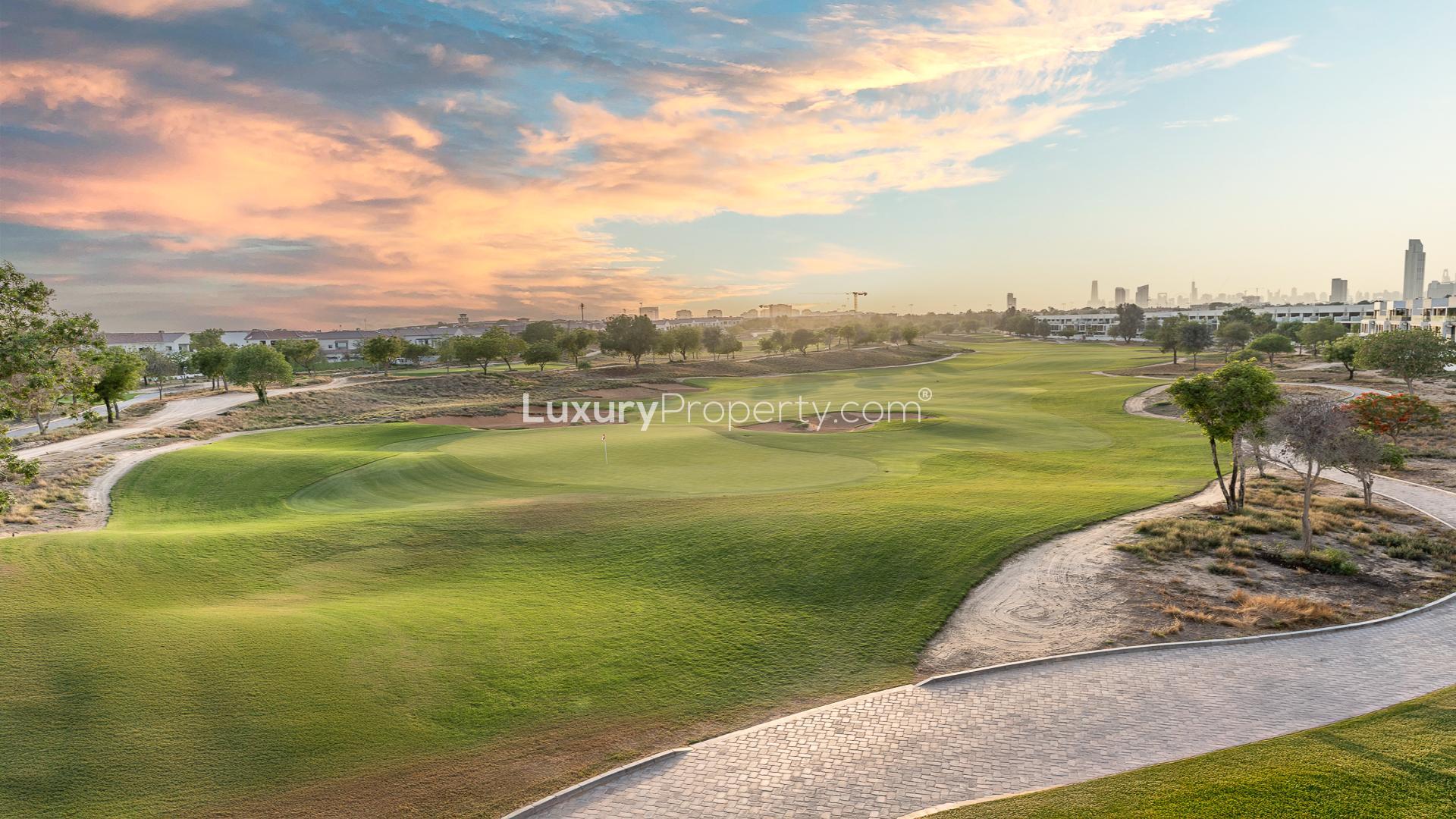 Modern open-plan kitchen and living area in Jumeirah Golf Estates villa for rent