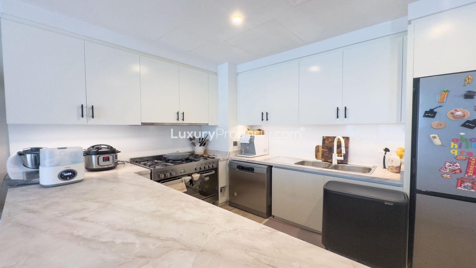 Modern kitchen in Arabian Ranches 2 villa, spacious dining area, bright and airy design