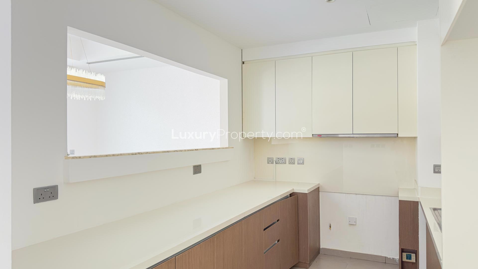 Sunny villa garden with pergola and blooming flowers in Reem Community, Arabian Ranches 2