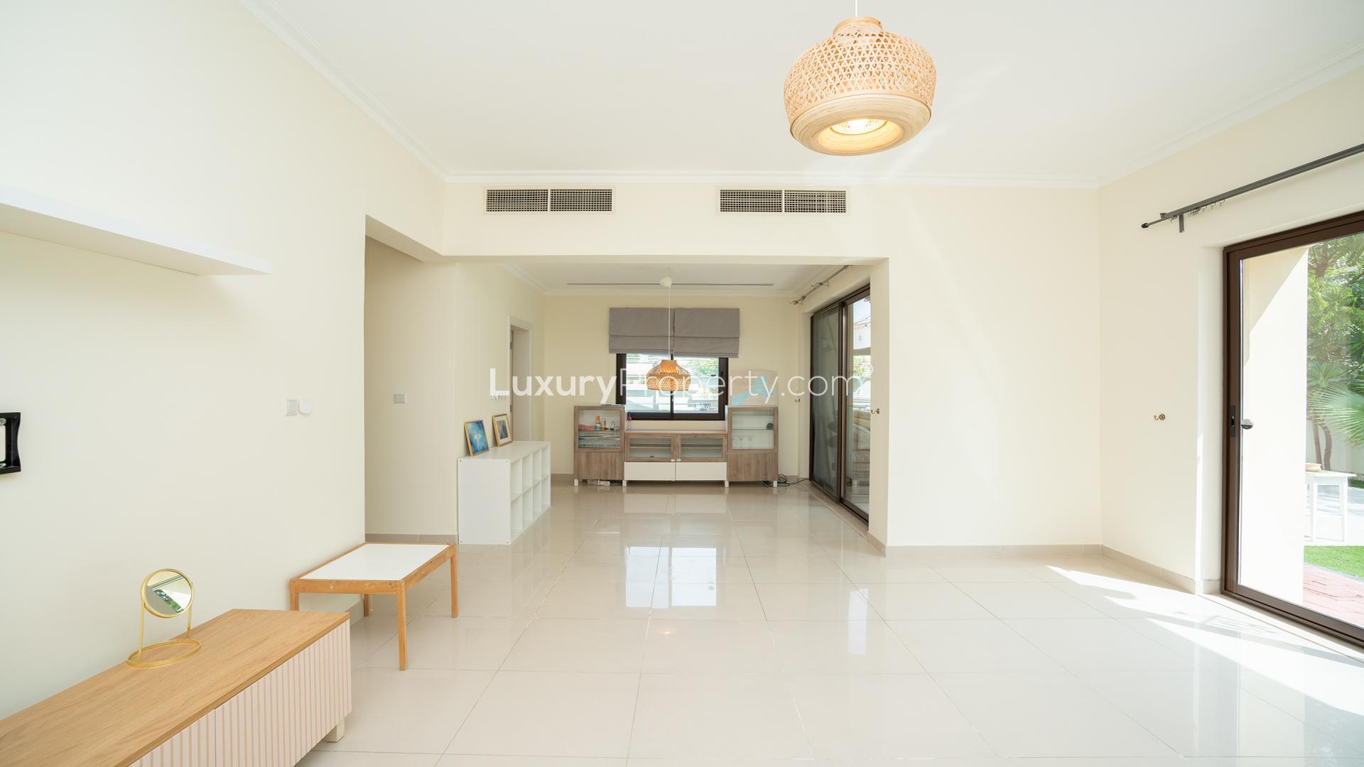 "Spacious living area in 4-bedroom villa, Arabian Ranches 2, Samara, with natural light.",Bright living area with garden view in Samara villa, Arabian Ranches 2