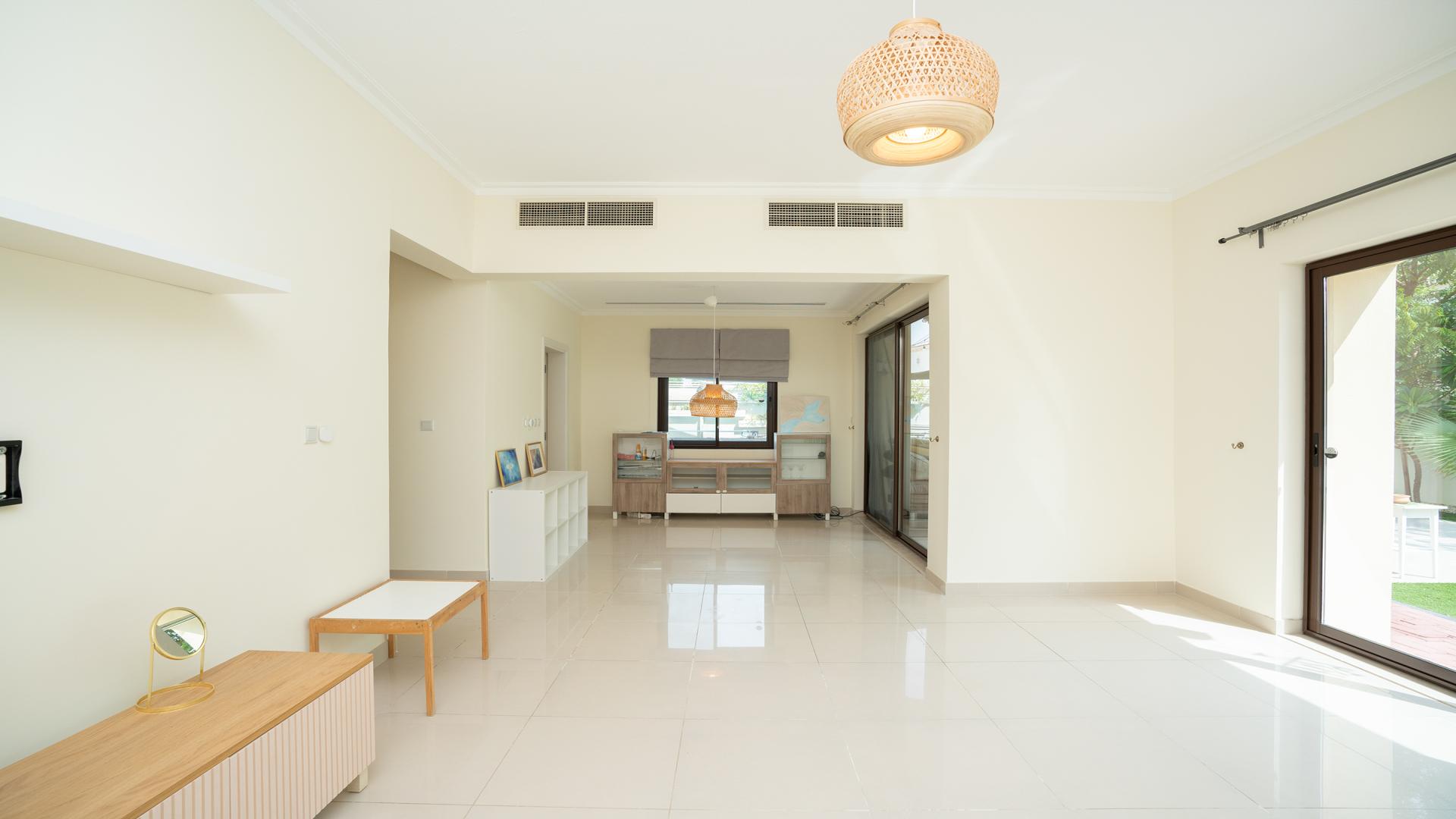 "Spacious living area in 4-bedroom villa, Arabian Ranches 2, Samara, with natural light.",Bright living area with garden view in Samara villa, Arabian Ranches 2