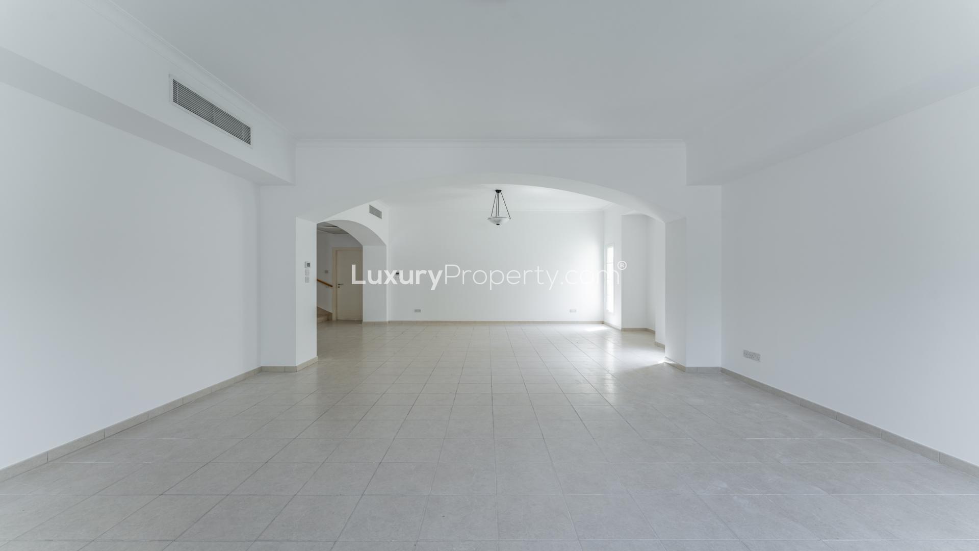 Elegant open-plan living area in 4-bedroom villa, Deema, The Lakes, with large windows