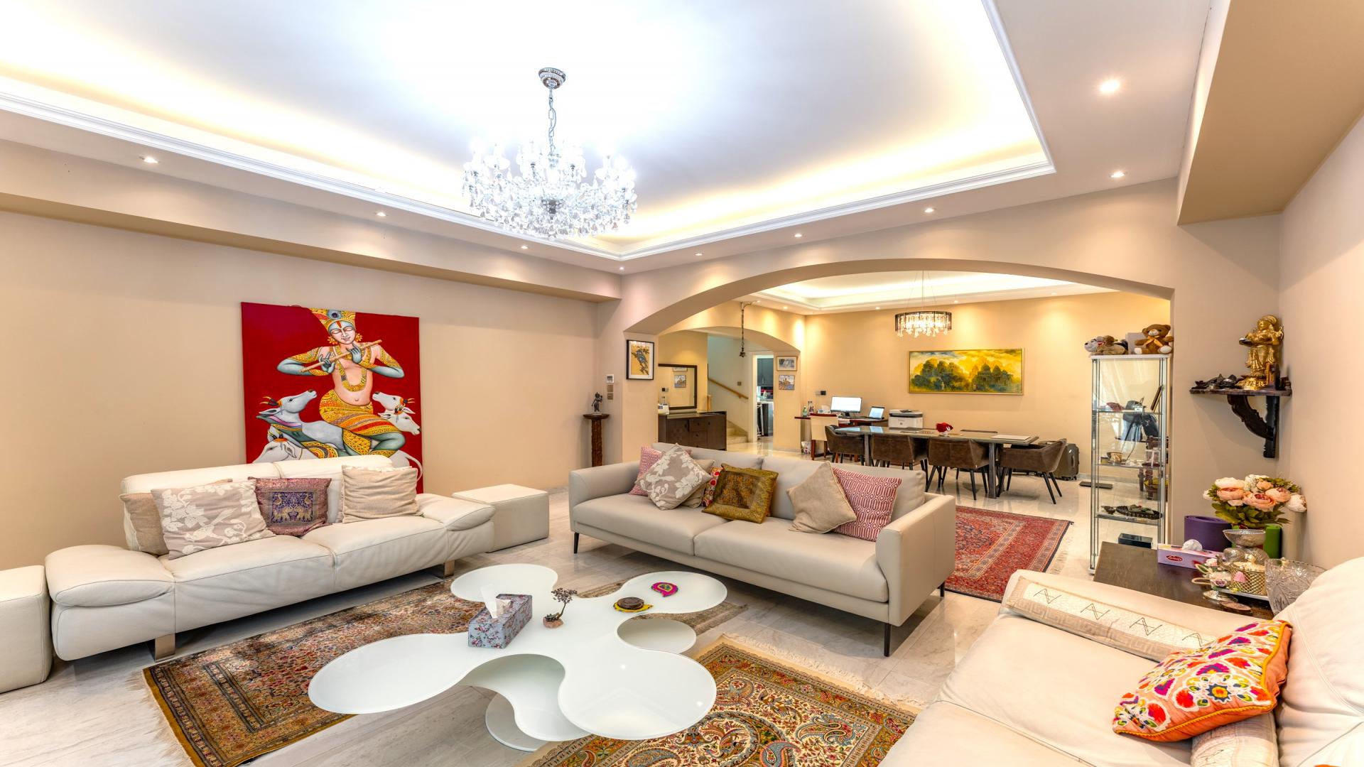 Luxurious 4-bedroom villa exterior in Deema, The Lakes community, surrounded by lush greenery