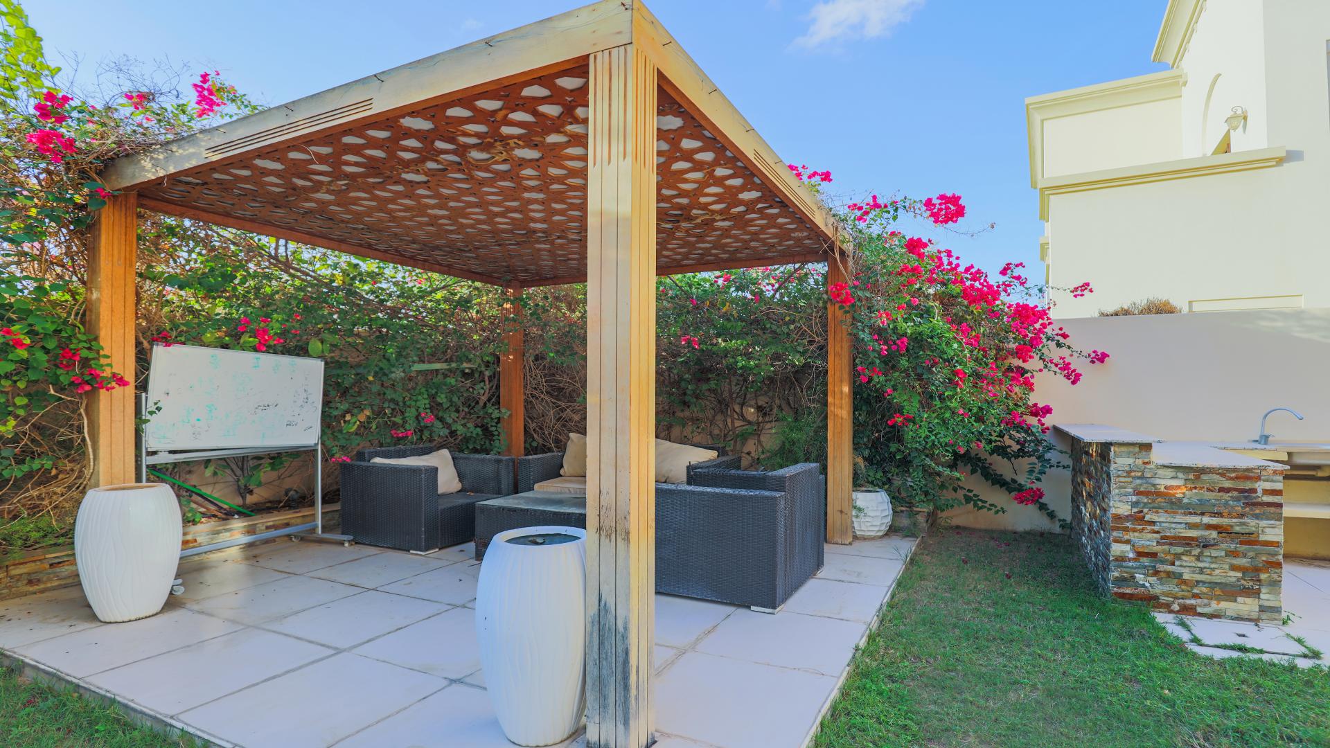 Upgraded villa with landscaped garden and seating area in Arabian Ranches 2, Casa community