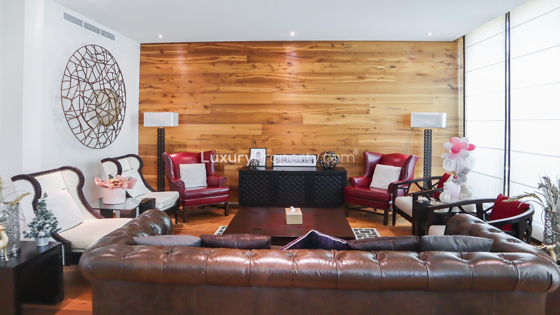 "Spacious garden of furnished four-bed villa in Jumeirah Islands, Cluster 36, for rent.",Furnished living room in four-bed villa, Jumeirah Islands, featuring elegant seating and decor