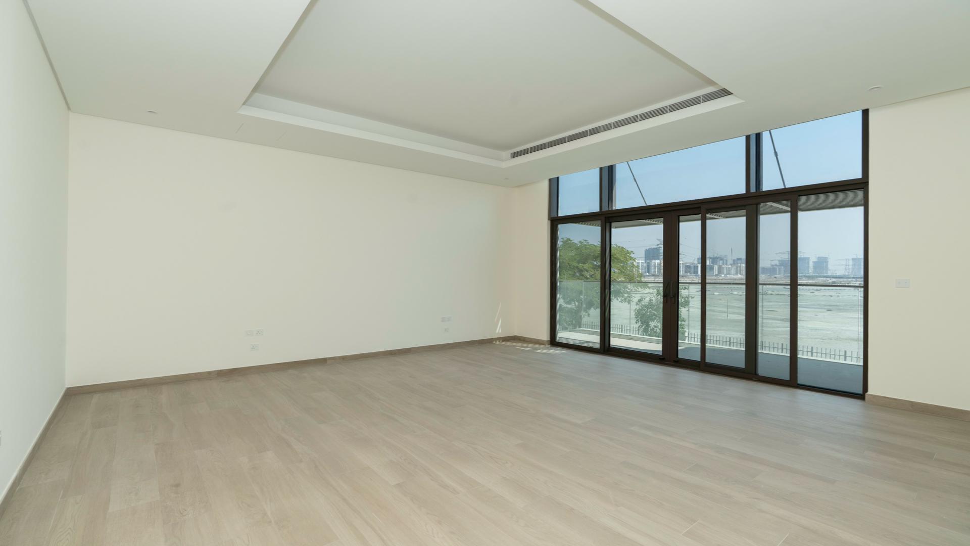 "Spacious balcony view from District One villa in Mohammed Bin Rashid City for rent.",Spacious living room with large windows in District One villa, Mohammed Bin Rashid City