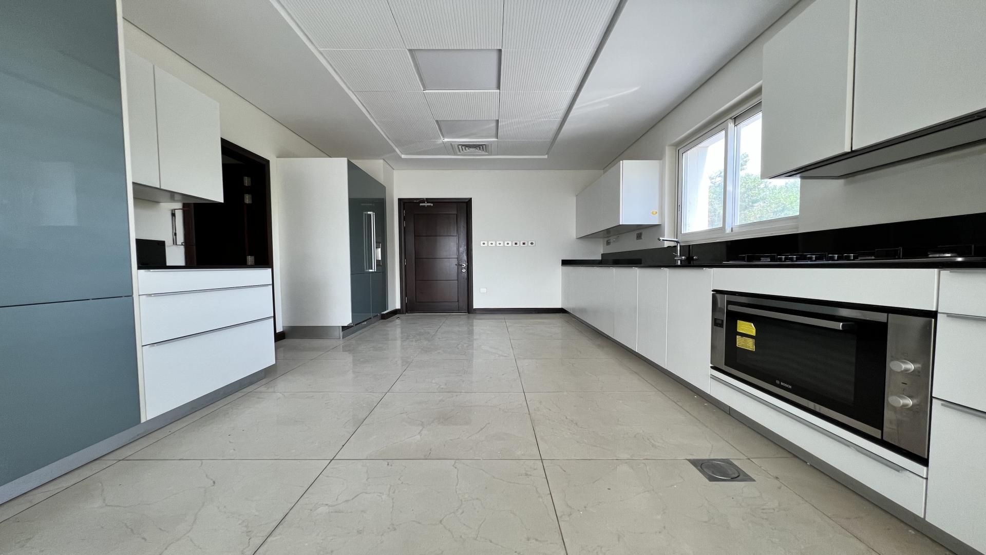 Spacious living room with large windows in Whispering Pines villa, Jumeirah Golf Estates