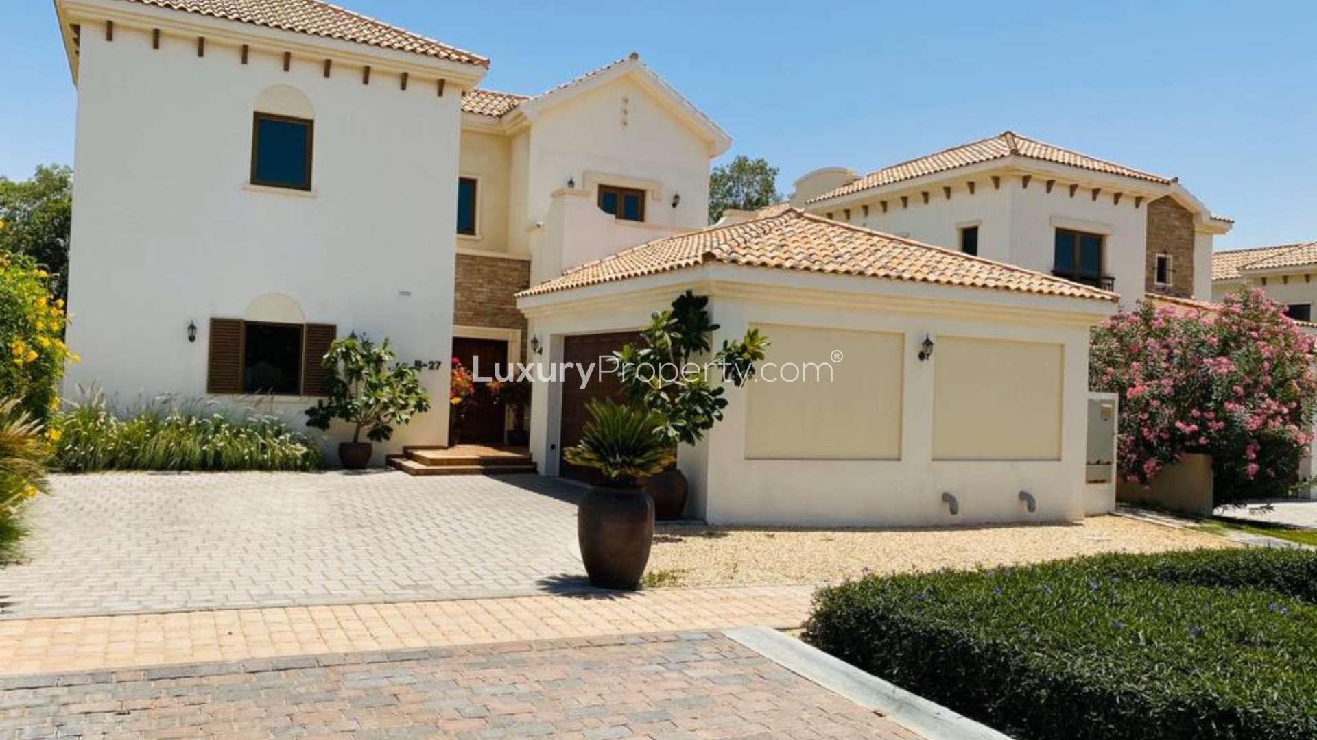 Family villa exterior with garage and garden, Jumeirah Golf Estates, Earth community