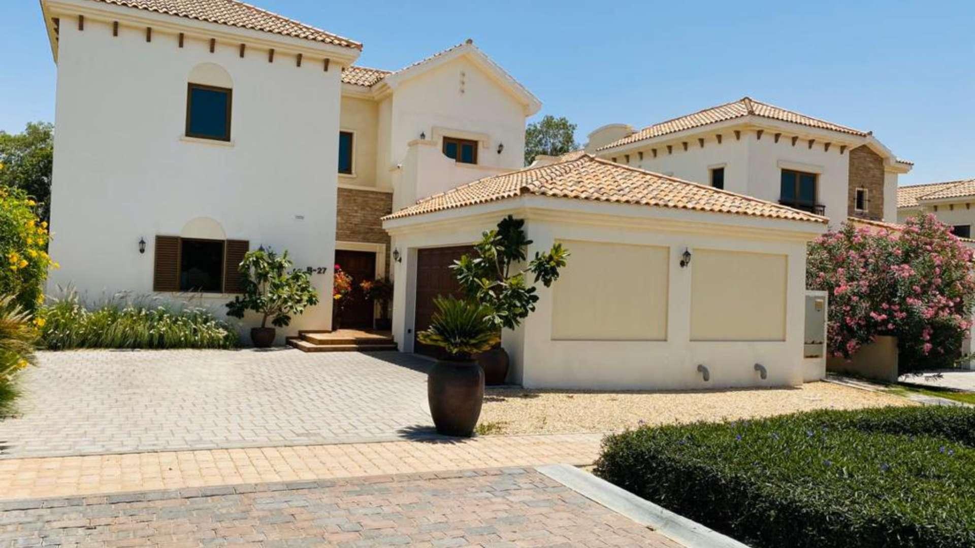 Family villa exterior with garage and garden, Jumeirah Golf Estates, Earth community