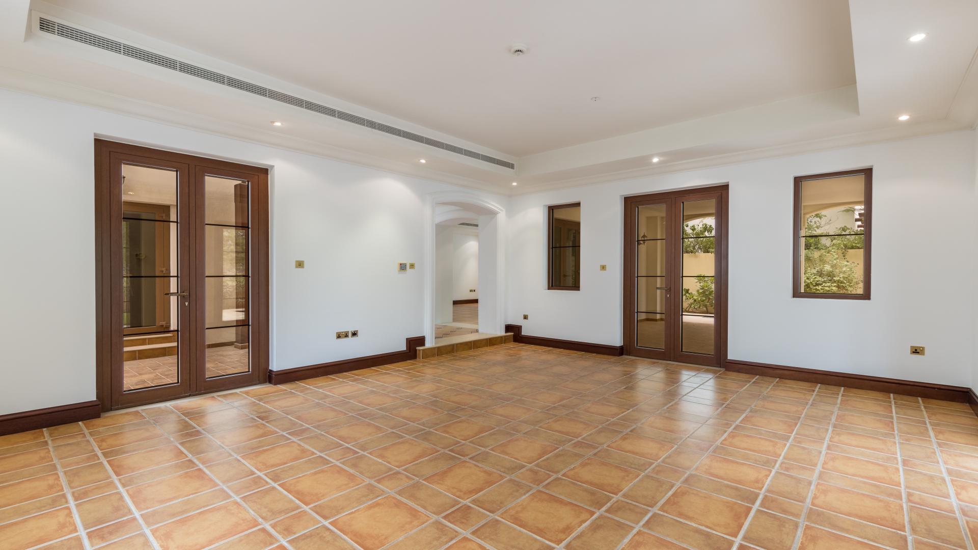 "Villa balcony view of lush golf course at Jumeirah Golf Estates, Earth community.",Spacious villa interior with tiled flooring, large windows, Jumeirah Golf Estates, Earth community