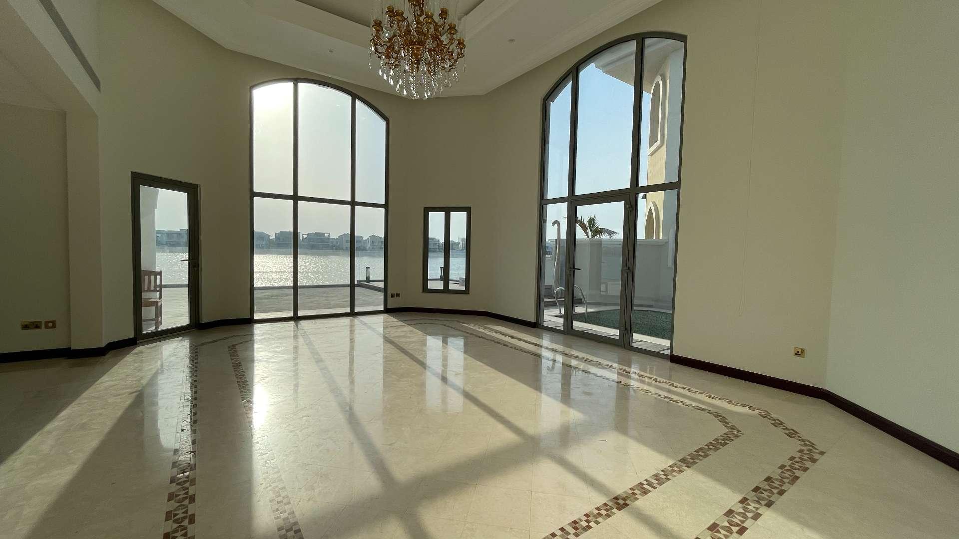 "Beachfront view from Garden Home Villa, Palm Jumeirah, sunny day, serene waters.",Spacious living room with waterfront view in Palm Jumeirah Garden Home Villa