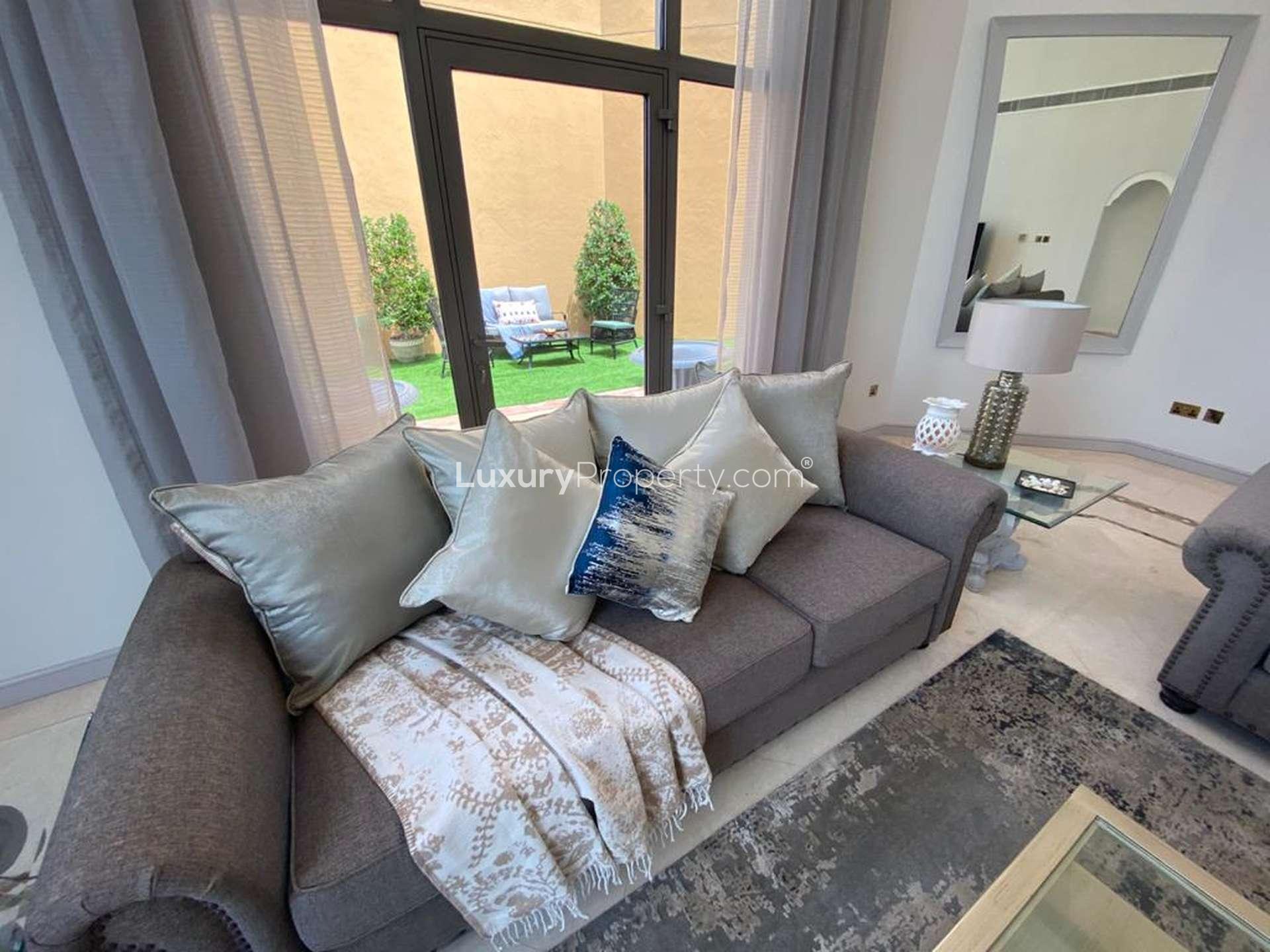 Luxurious living room in 4-bedroom villa, Palm Jumeirah, with large windows and elegant decor