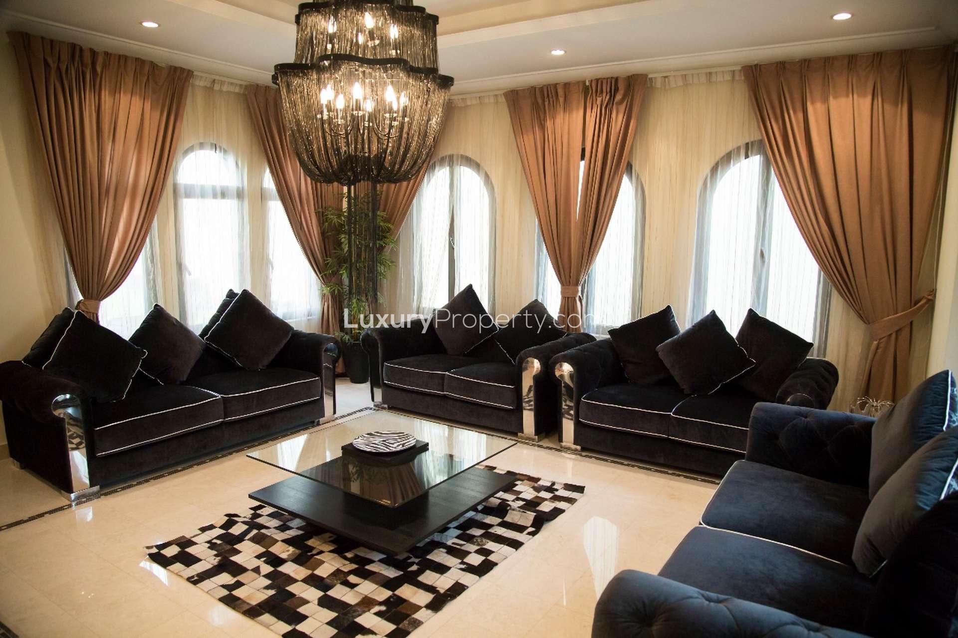 Luxury 4-bedroom villa exterior on Frond D, Palm Jumeirah, with garage and palm trees
