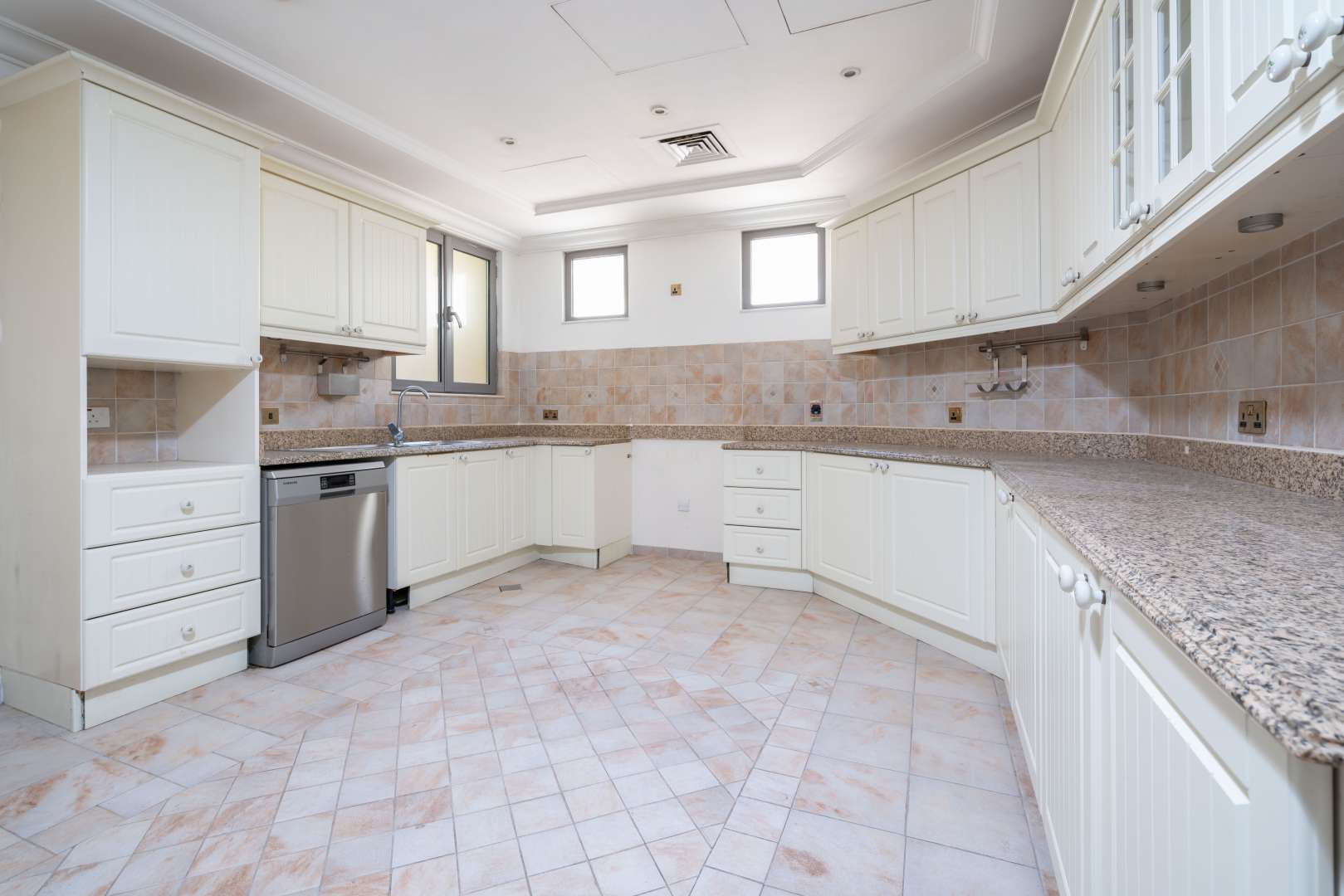 Spacious living room with large windows, Palm Jumeirah villa, overlooking pool and garden